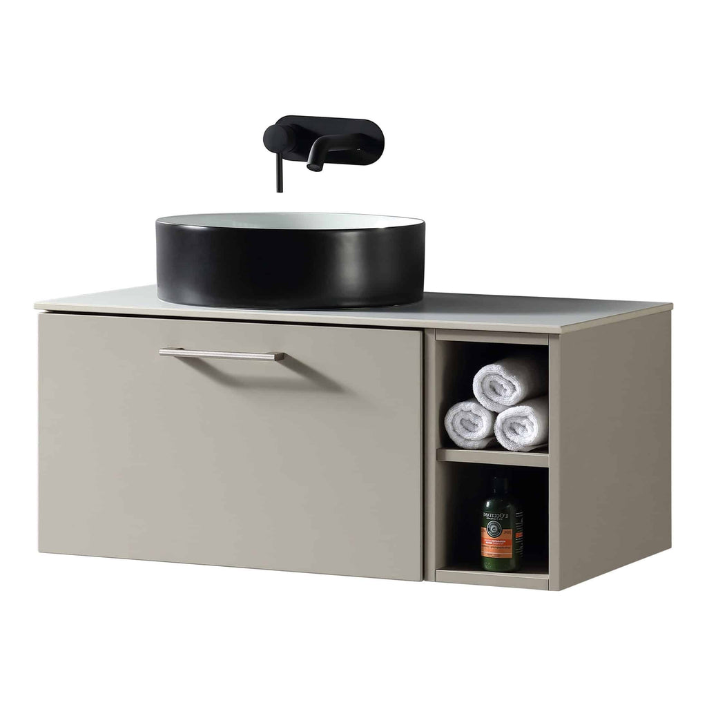 Sleek modern bathroom vanity with integrated storage, matte beige finish, black vessel sink, and wall-mounted black tap, designed for stylish and functional bathroom décor.