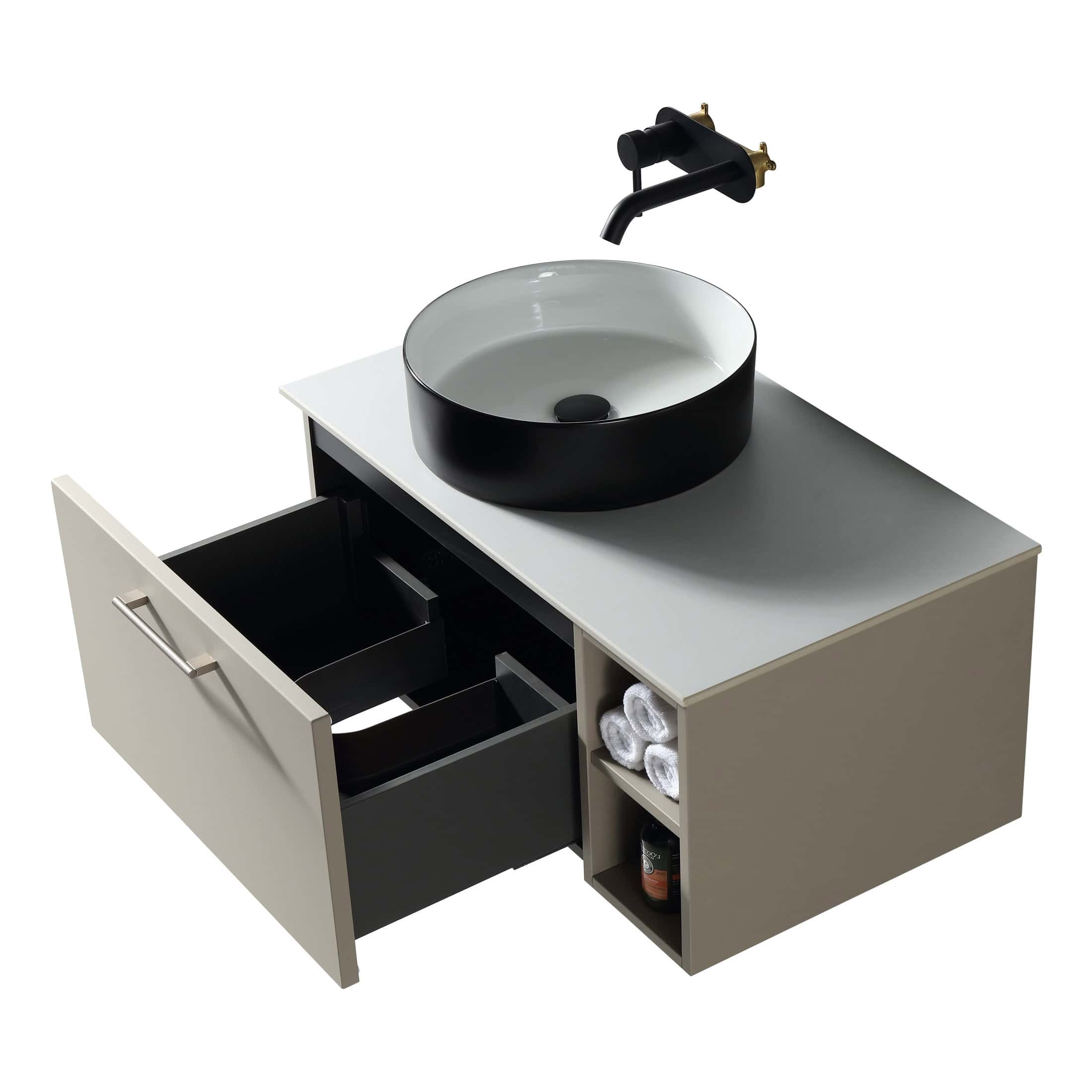 Black and white round vessel sink with matte black finish, mounted on a contemporary bathroom vanity with open storage and drawers, featuring modern black and gold fixtures, ideal for stylish bathroom design.