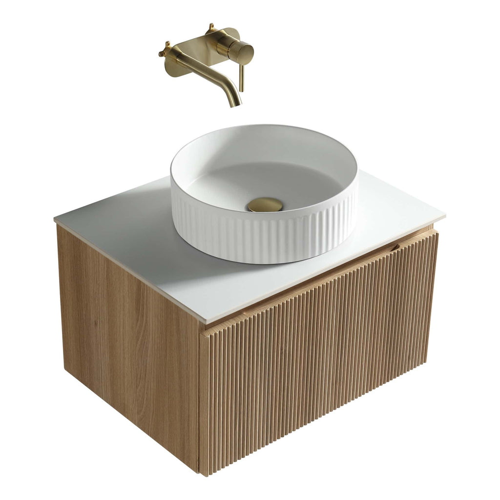 Sleek white bathroom sink with a ribbed design, mounted on a modern wooden vanity with a natural finish, complemented by a stylish gold wall-mounted faucet, perfect for contemporary bathroom designs.