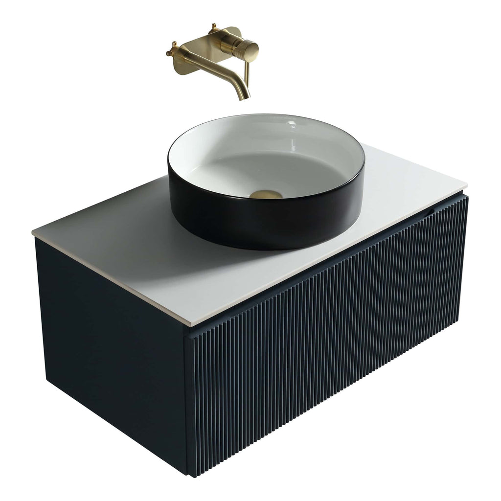 Stylish modern bathroom vanity with a black cabinet, white countertop, black and white vessel sink, and brushed brass wall-mounted tap, perfect for contemporary bathroom decor.
