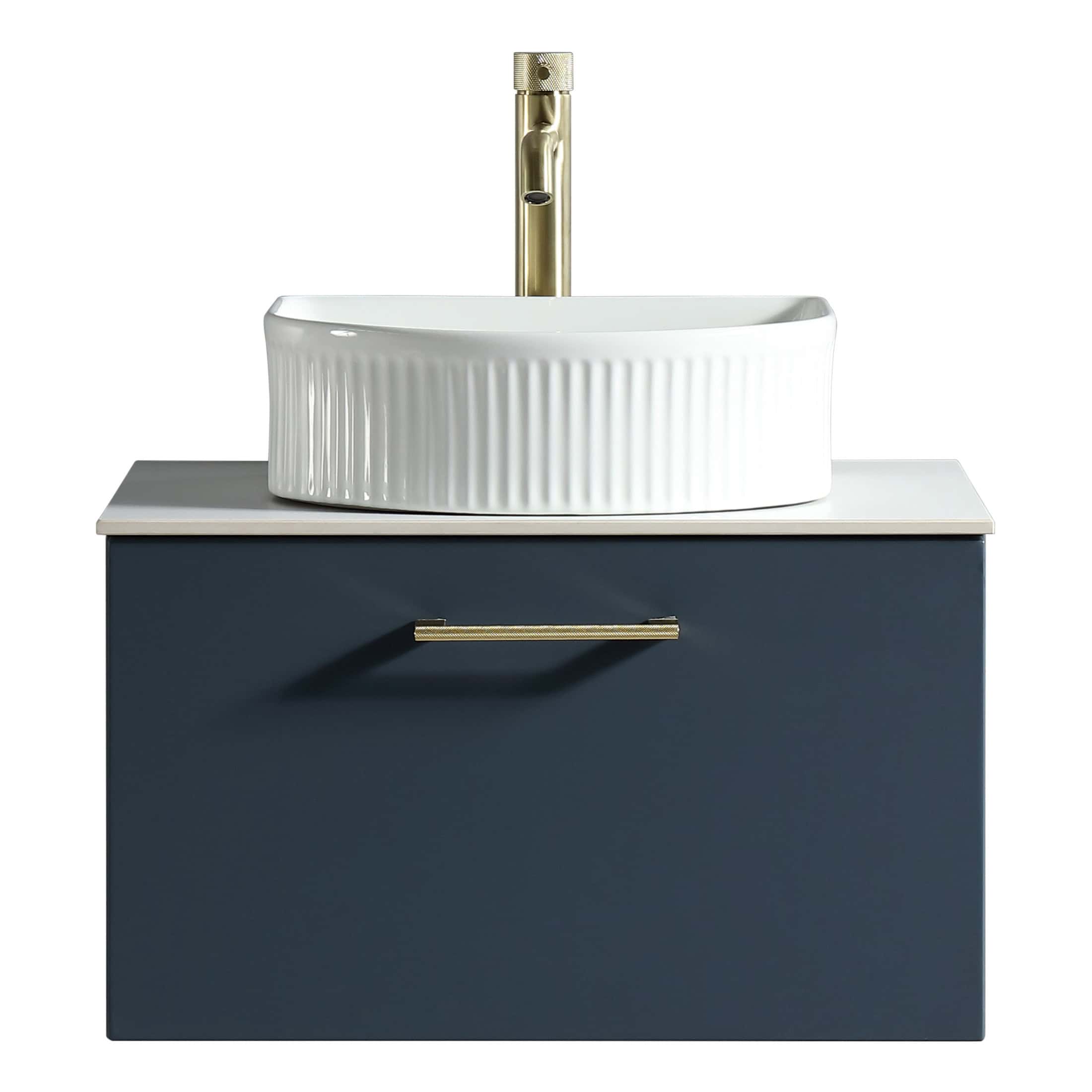 Sleek white ceramic bathroom sink with a ribbed design, mounted on a modern navy blue vanity unit with a gold handle, perfect for contemporary bathroom decor.