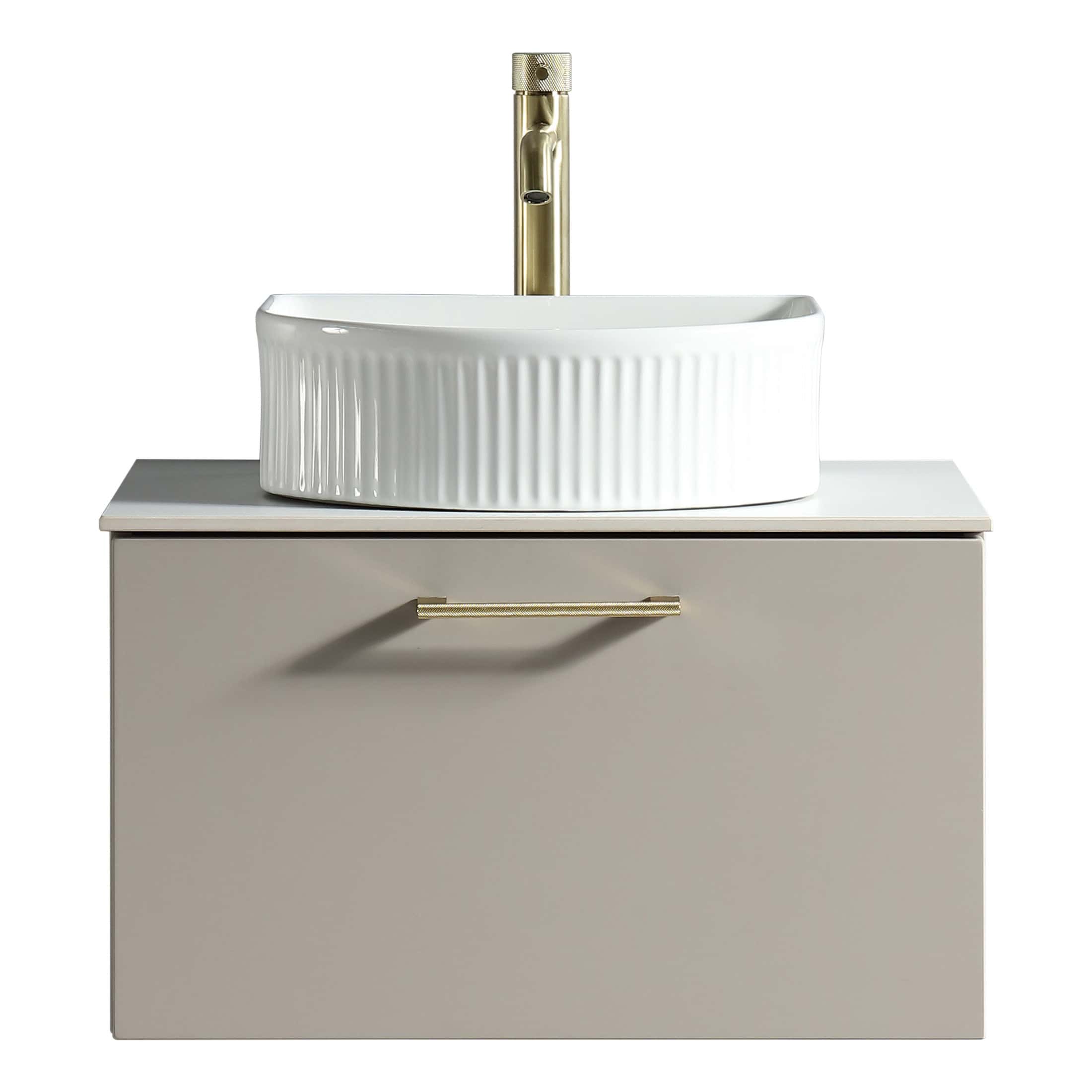 Sleek beige bathroom vanity with integrated cabinet and modern brass handle, supporting a stylish white ceramic vessel sink with ribbed design and brass freestanding faucet for contemporary bathroom decor.