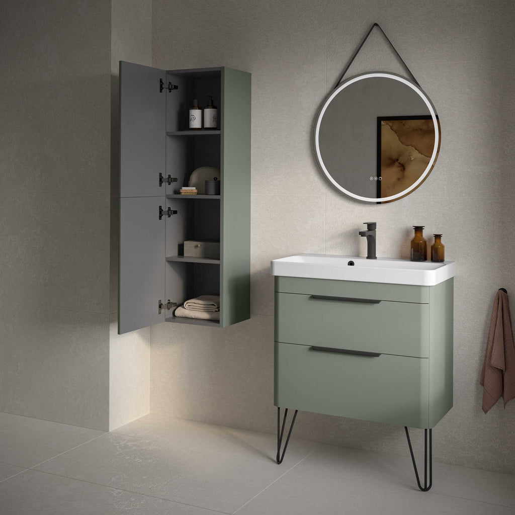 Sleek modern bathroom vanity with green finish and black hairpin legs, paired with a matching wall cabinet, under a round LED-lit mirror, featuring minimalist design and elegant bathroom storage solutions.