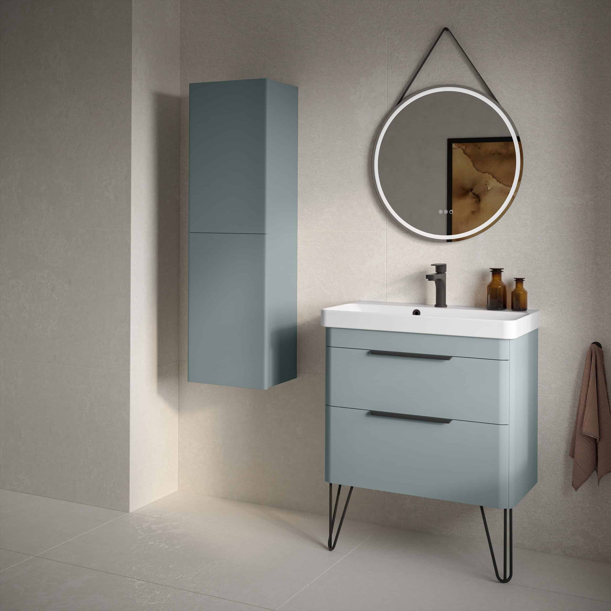 Contemporary blue bathroom vanity with sleek black handles, mounted mirror with LED lighting, and matching tall storage cabinet, creating a modern and stylish bathroom space.