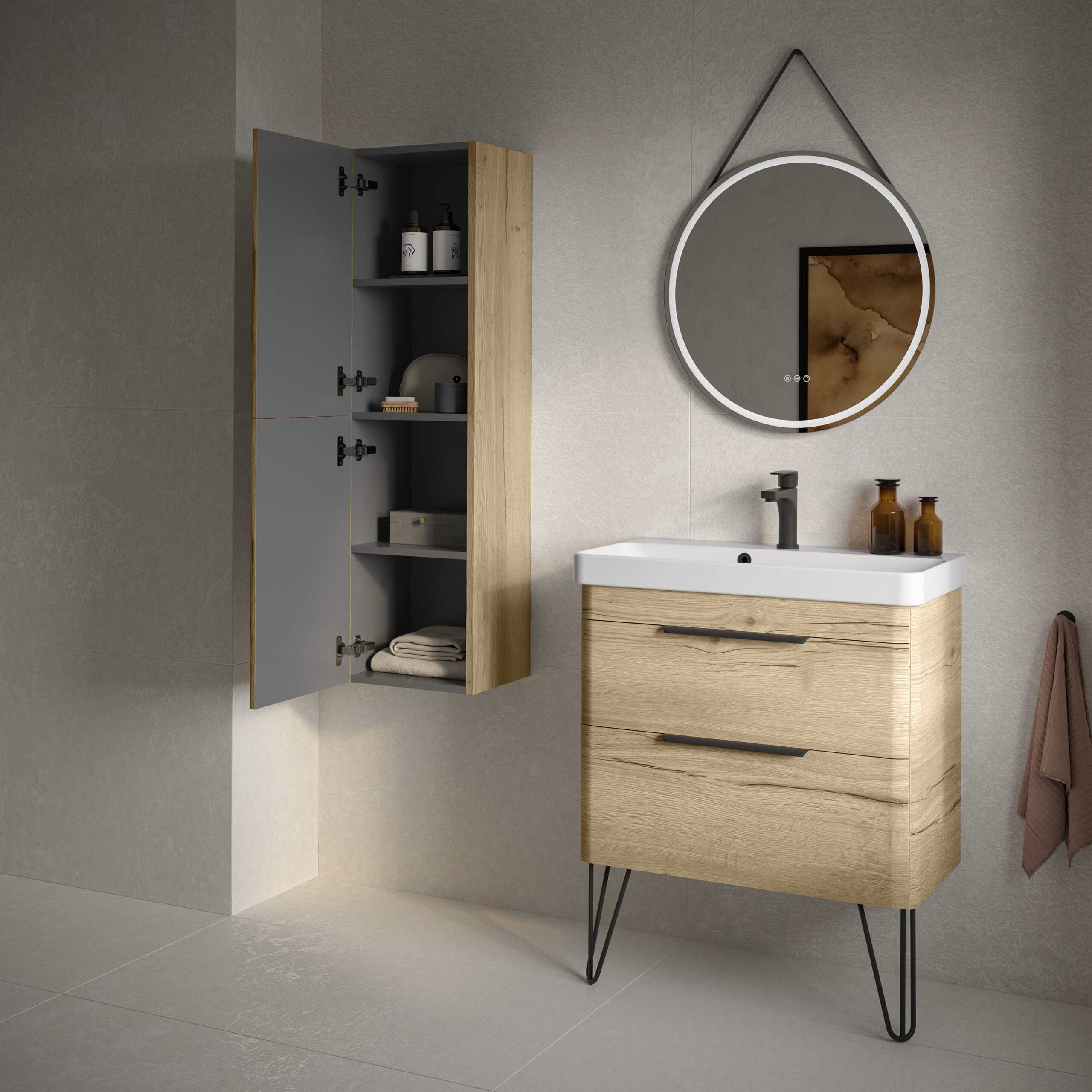 Modern bathroom with light wood vanity unit, circular wall mirror with LED lighting, storage cabinet, neutral tiled walls, and minimalistic fixtures for a contemporary look.