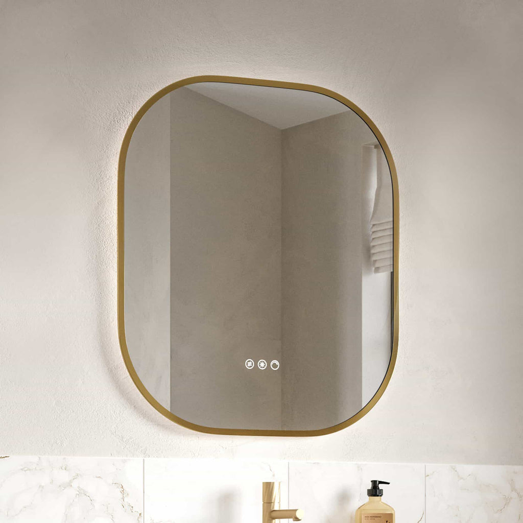 Sleek modern bathroom mirror with touch controls, gold frame, and backlit LED lighting in a contemporary bathroom setting. The mirror adds elegance and functionality to bathroom decor.