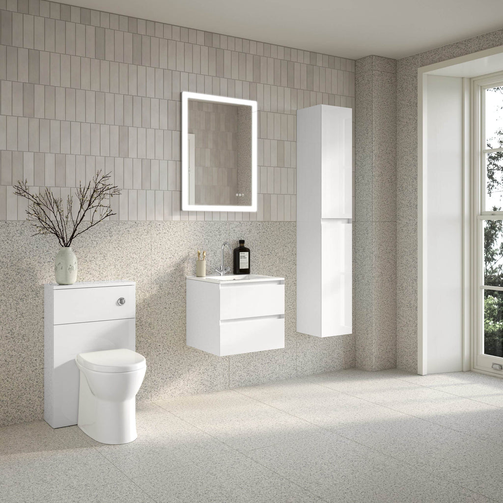 Minimalist white bathroom with modern fixtures, floating vanity, and built-in storage units, featuring a large window and soft neutral tones for a clean, contemporary look.