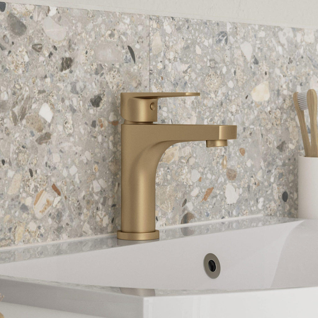 Sleek gold bathroom basin tap with modern design on terrazzo countertop, perfect for contemporary bathroom decor. Durable and stylish fixture for luxury bathroom spaces.