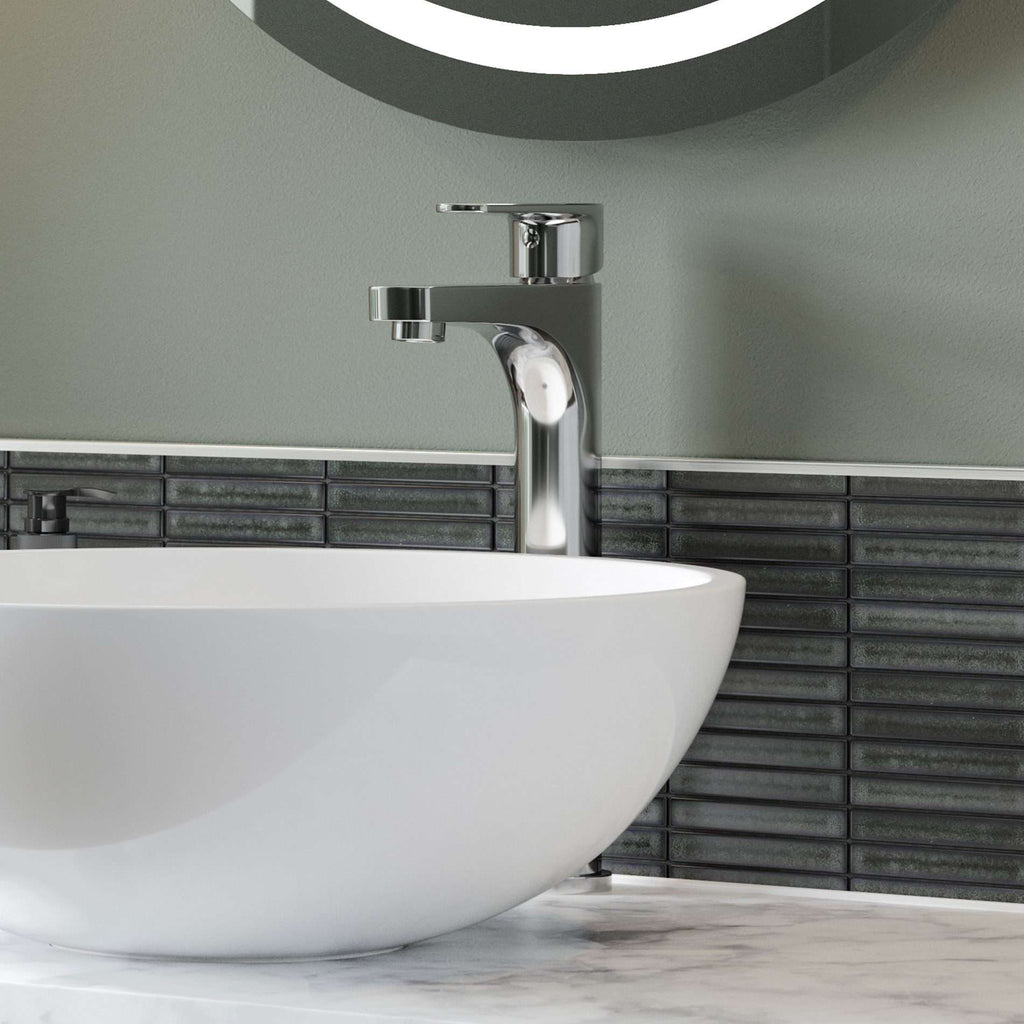 Sleek modern bathroom sink with chrome tap and black tiled backsplash, incorporating stylish and contemporary bathroom design elements.