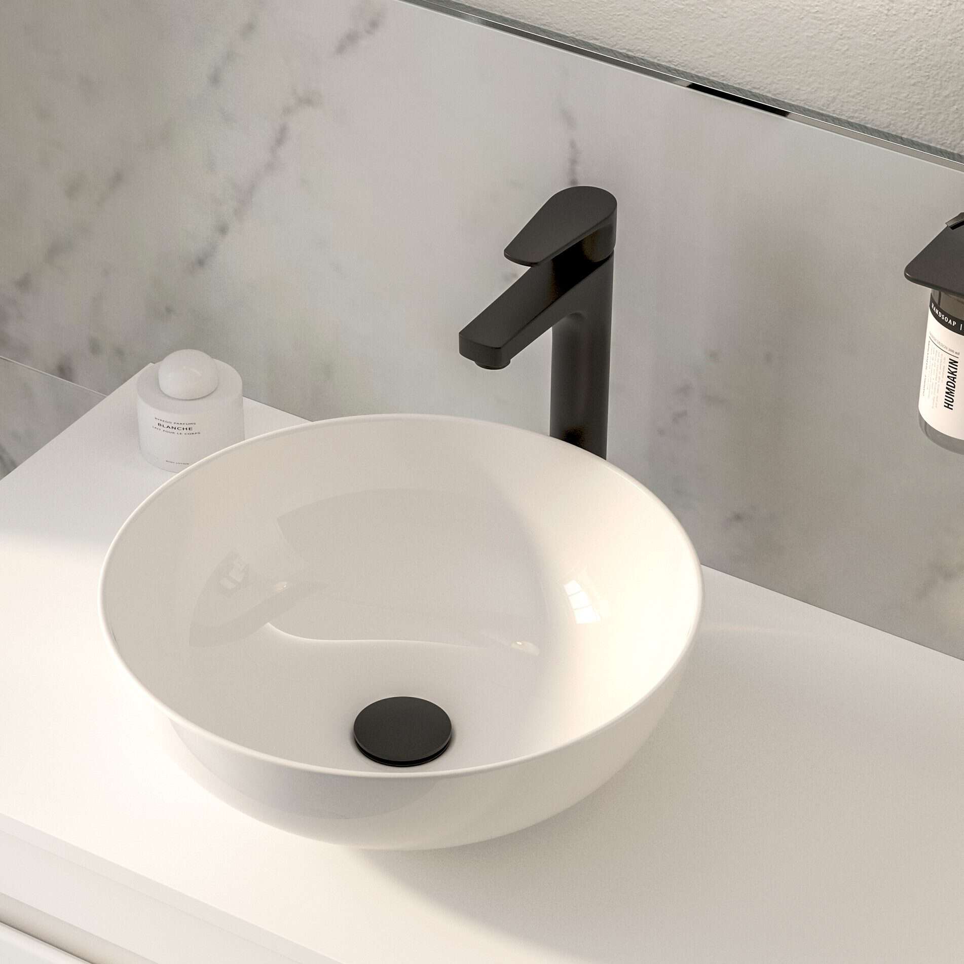 Contemporary white vessel bathroom sink with matte black faucet on a sleek white vanity with modern décor.