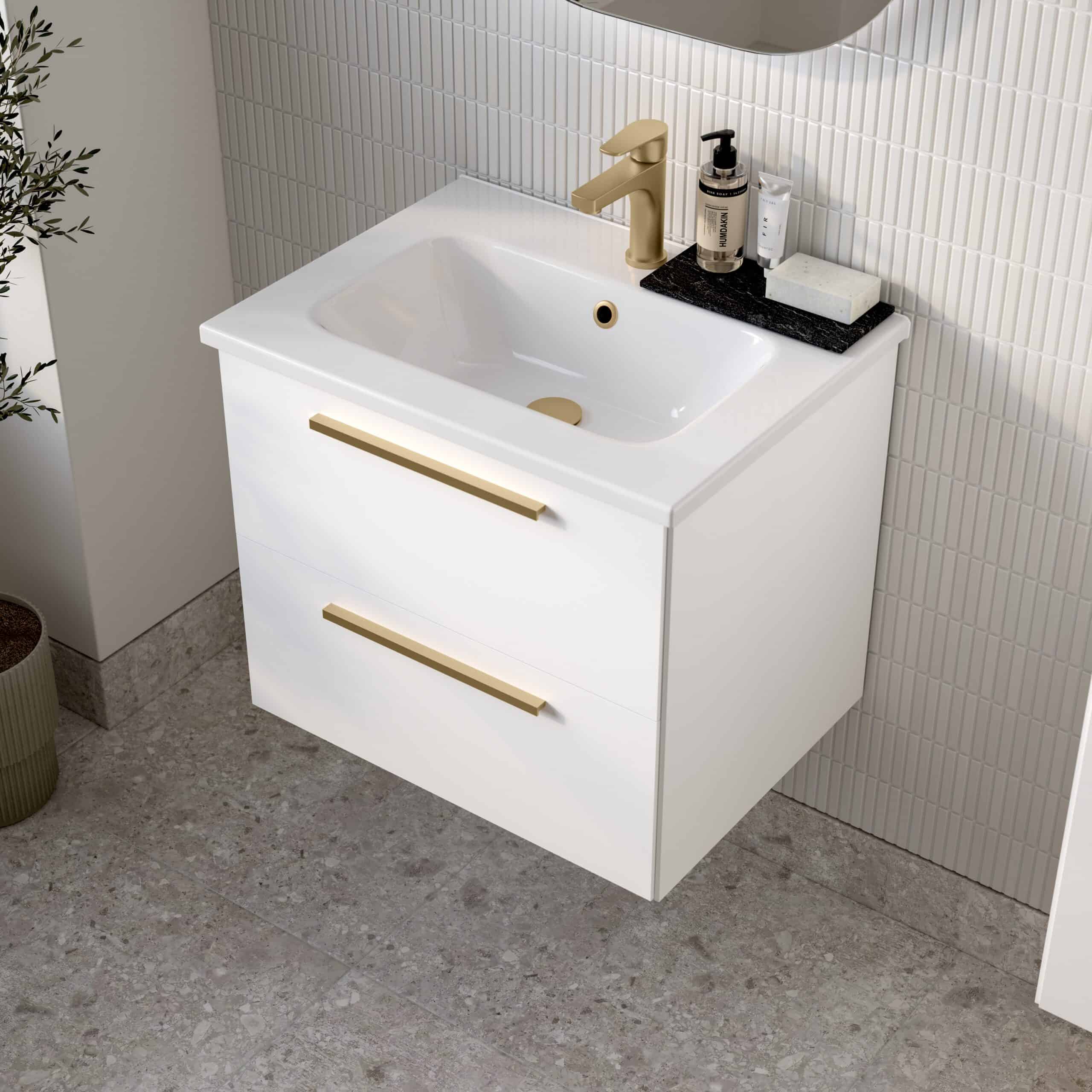 Contemporary white bathroom vanity with integrated sink, featuring sleek gold handles and fixtures, set against modern tiled walls, perfect for stylish bathroom renovations.