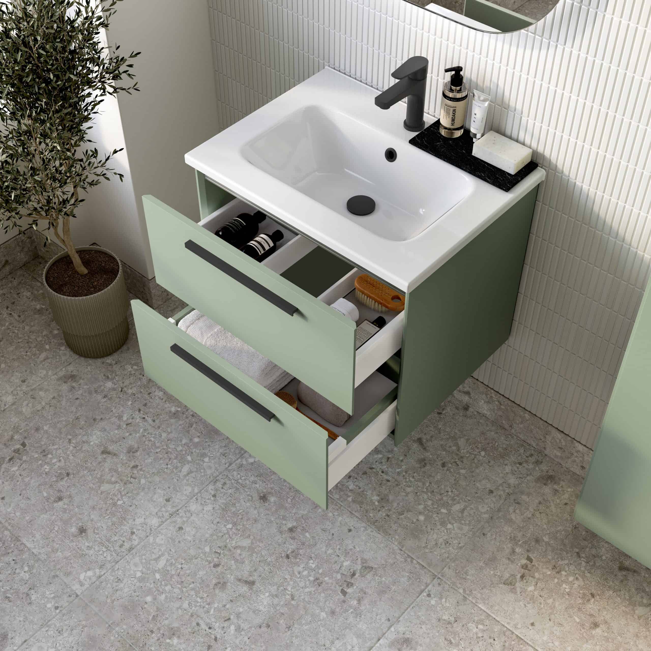 Modern green bathroom vanity with integrated sink, black tap, and open drawers for bathroom storage, surrounded by elegant decor and tiles. Perfect for contemporary bathroom design.