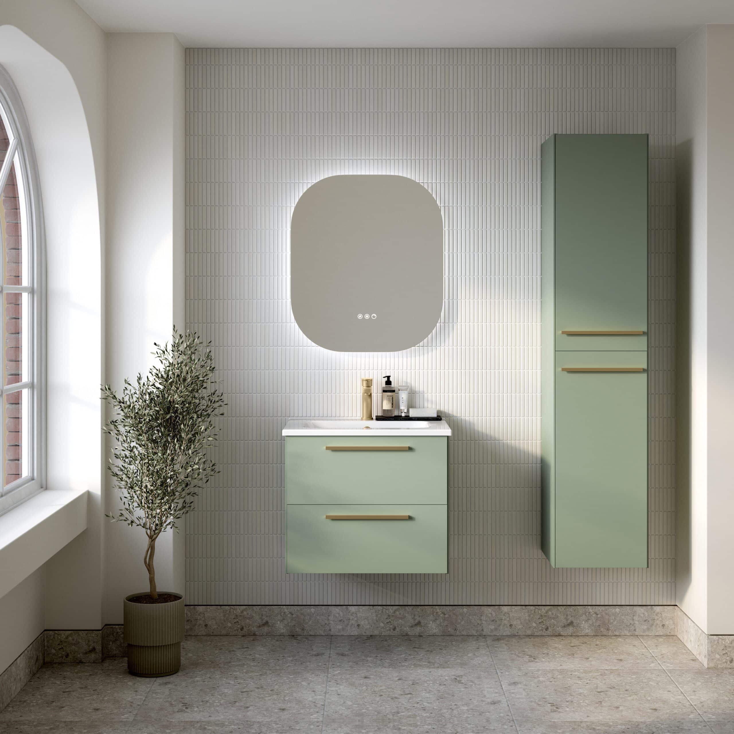 Modern green bathroom vanity with matching tall storage cabinet, illuminated mirror, and decorative potted plant in a minimalist bathroom design.