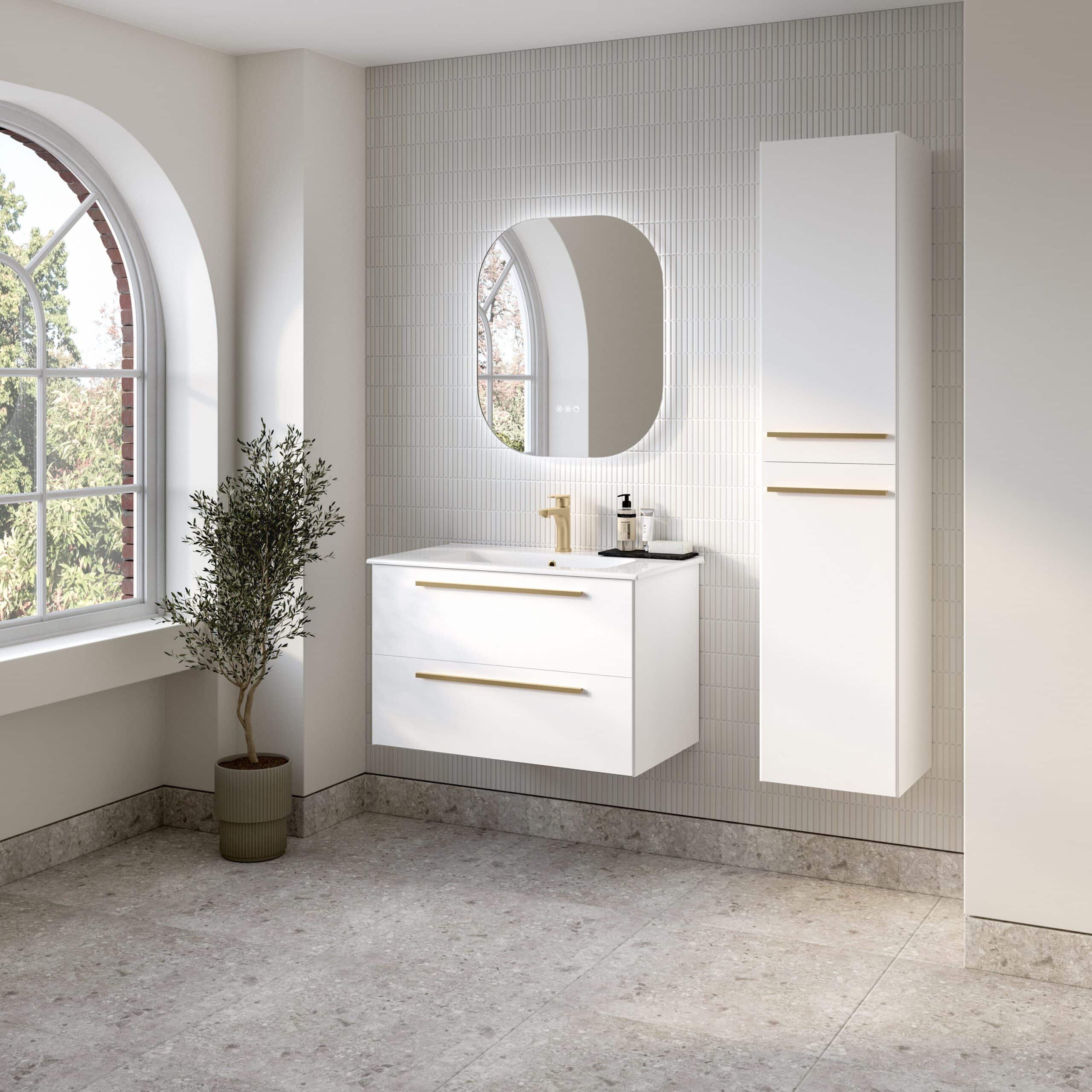 Sleek modern white bathroom vanity with gold accents, wall-mounted cabinet and oval mirror in a bright, minimalist bathroom setting with large arched window and natural light.