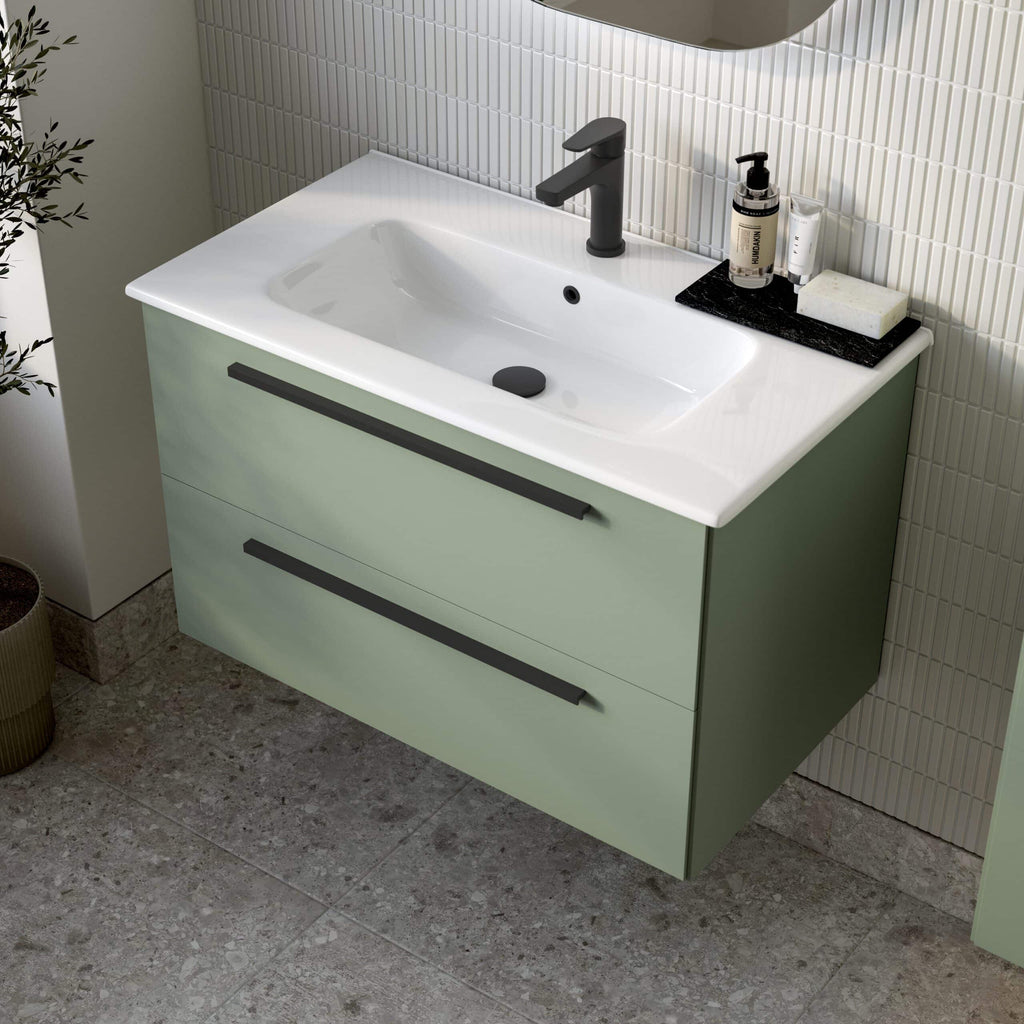 Modern green bathroom vanity unit with integrated sink and sleek black faucet, complemented by contemporary bathroom accessories for a stylish space.