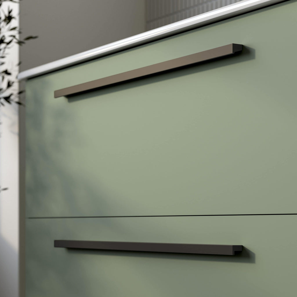 Sleek green bathroom cabinet with modern grey handles, showcasing minimalist bathroom furniture design. Perfect for contemporary bathroom storage solutions.