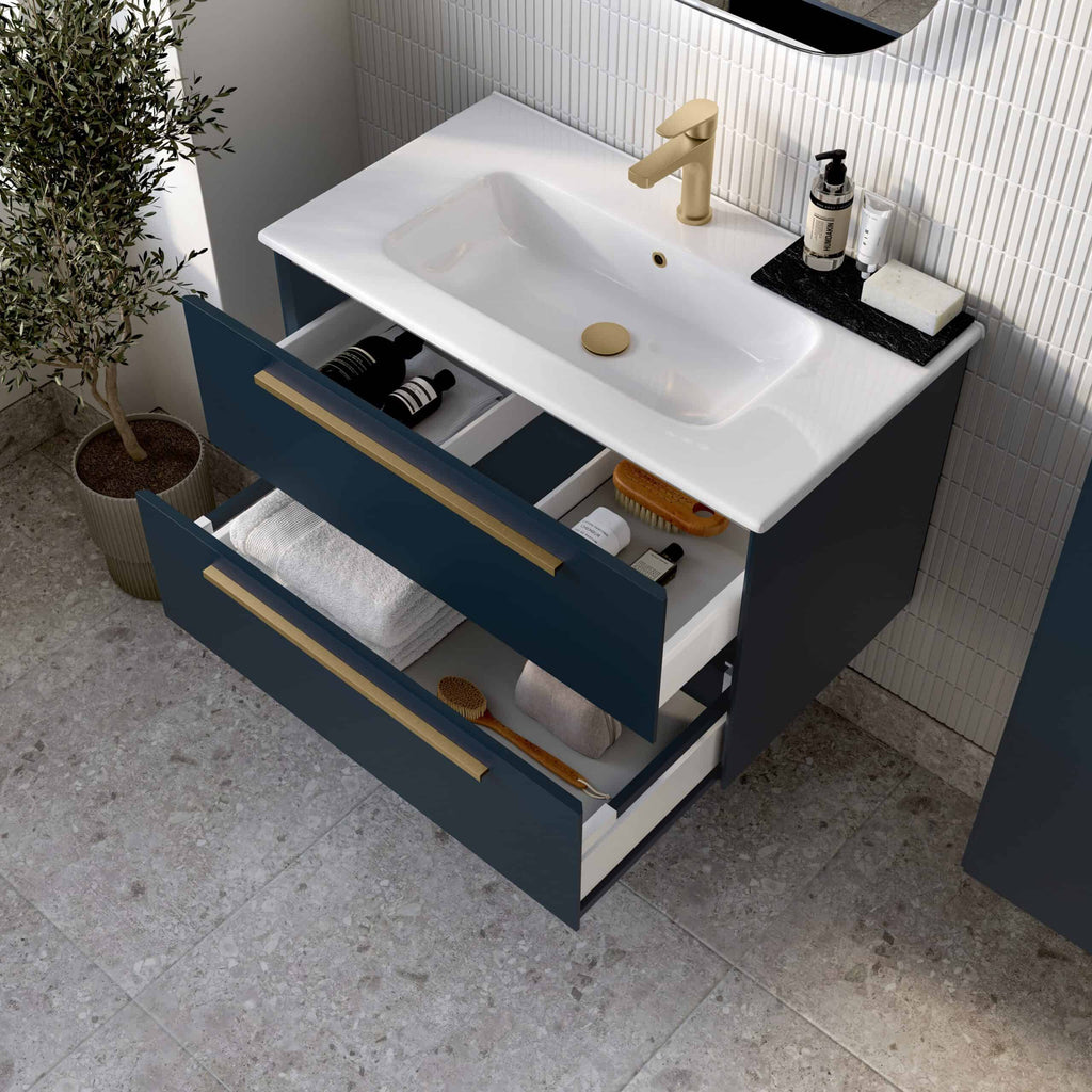 Mirror above modern bathroom basin with drawers containing toiletries and towels, navy blue and cream colour scheme, contemporary bathroom vanity unit, stylish and functional bathroom furniture, elegant bathroom storage solutions.