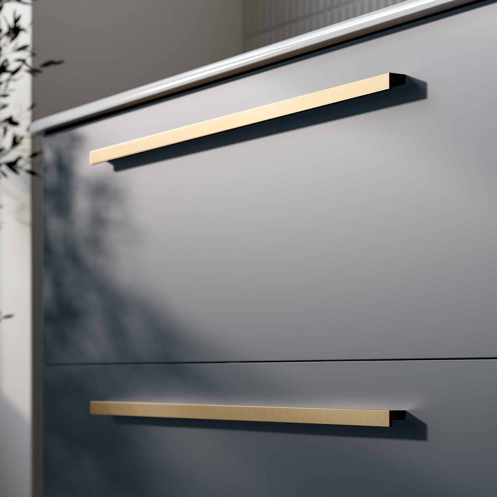 Sleek modern bathroom cabinet with gold handles, minimalist design, grey finish, and smooth surface for contemporary bathroom aesthetics. Ideal for stylish bathroom storage solutions.