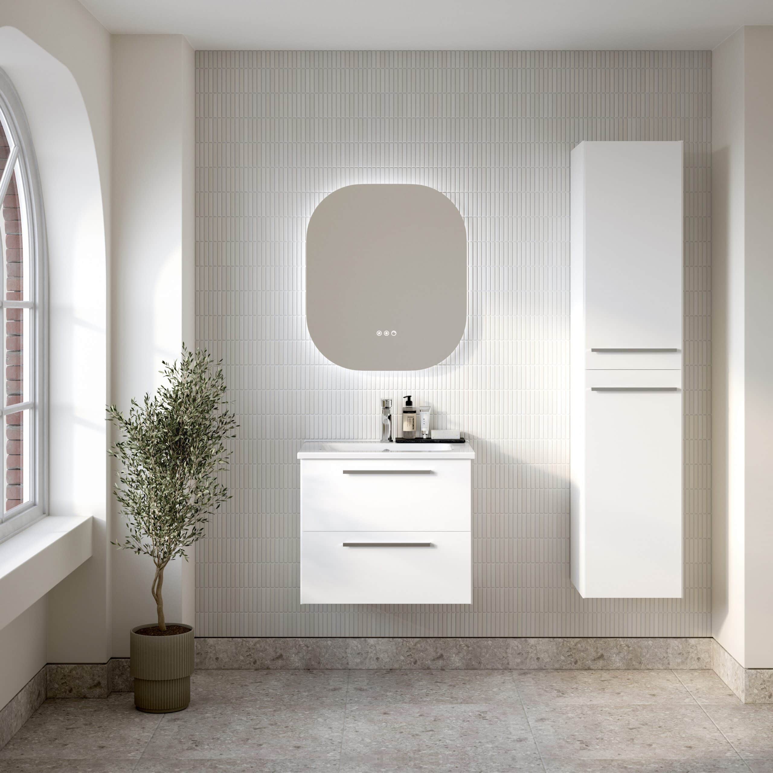 Contemporary white bathroom vanity with sleek drawer handles, modern mirror with backlighting, and tall storage cabinet in minimalist bathroom interior. Natural light from window highlights stylish and functional space.