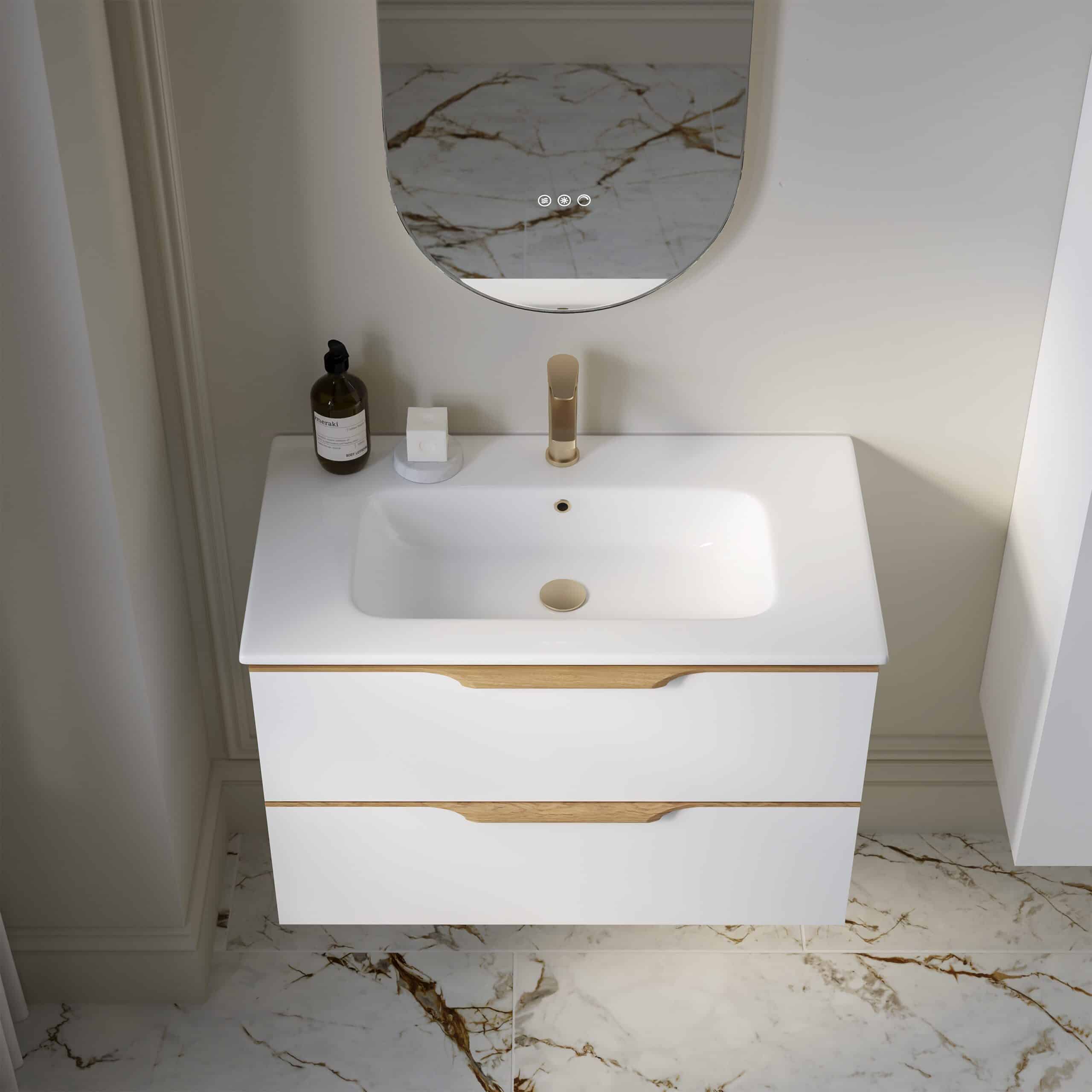 Sleek modern bathroom vanity with white finish and wooden accents, featuring a stylish under-mount sink and gold fixtures, set against a marble wall for luxury bathroom design.