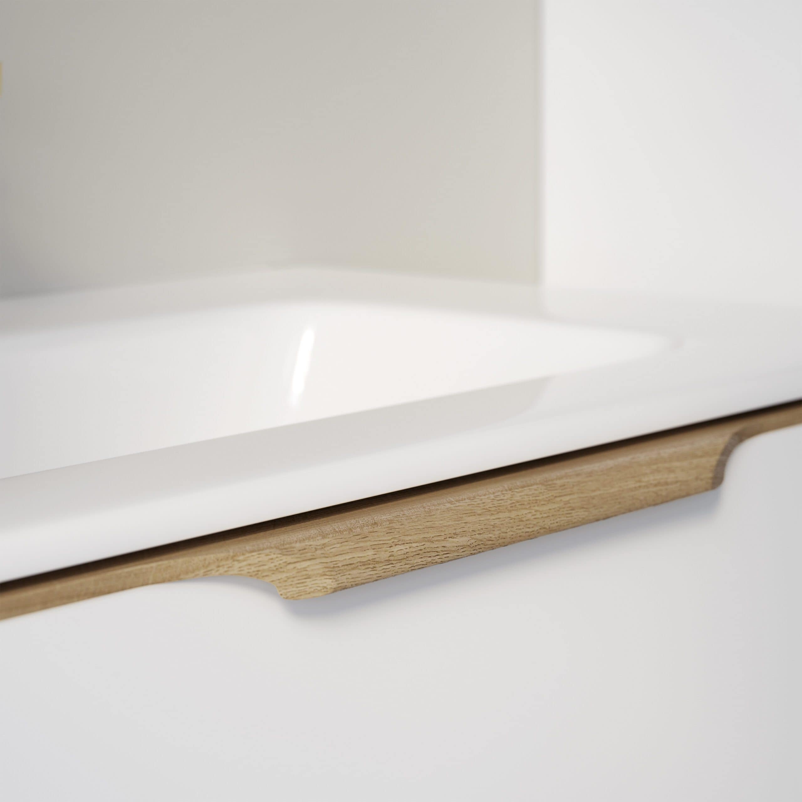 Shaker kitchen cabinet with white finish and natural wood accents, featuring a stylish curved wooden handle for a modern, minimalist bathroom or kitchen design.