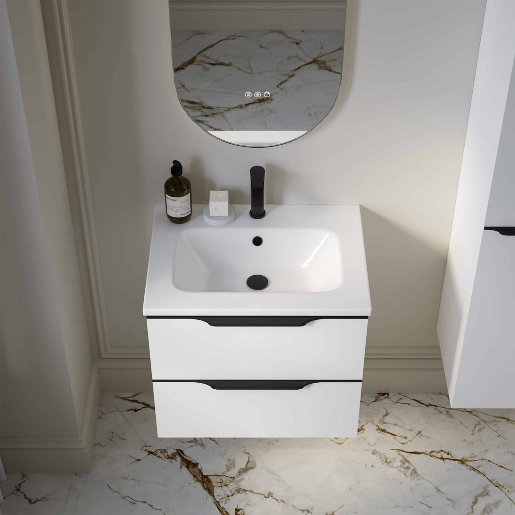 Modern white bathroom vanity with sleek black handles, integrated sink, and wall-mounted mirror featuring marble accents, ideal for contemporary bathroom bathroom bathroom decor and plumbing solutions.