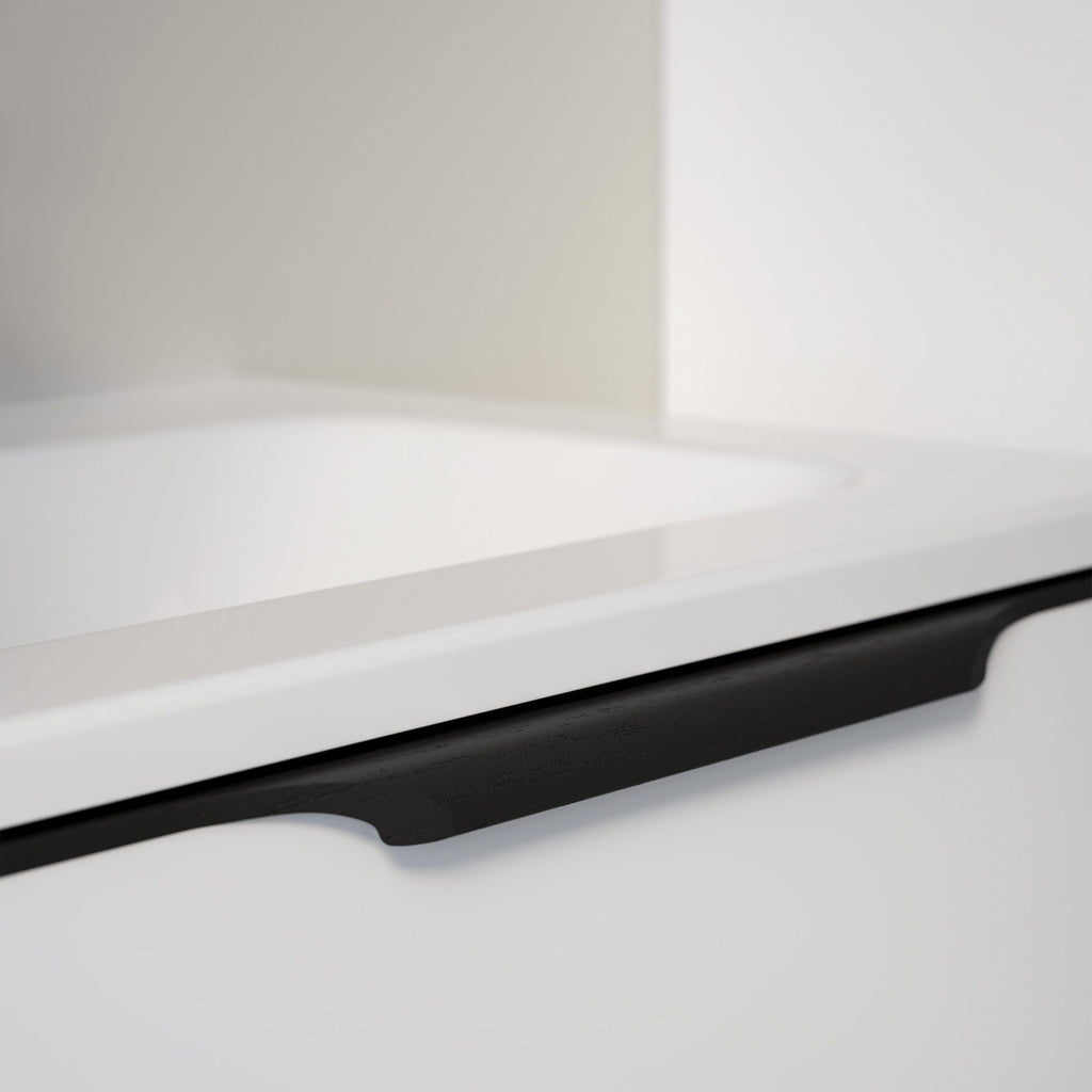 Modern white bathroom cabinet with sleek black handle, designed for contemporary style and practical storage solutions in bathroom interiors.