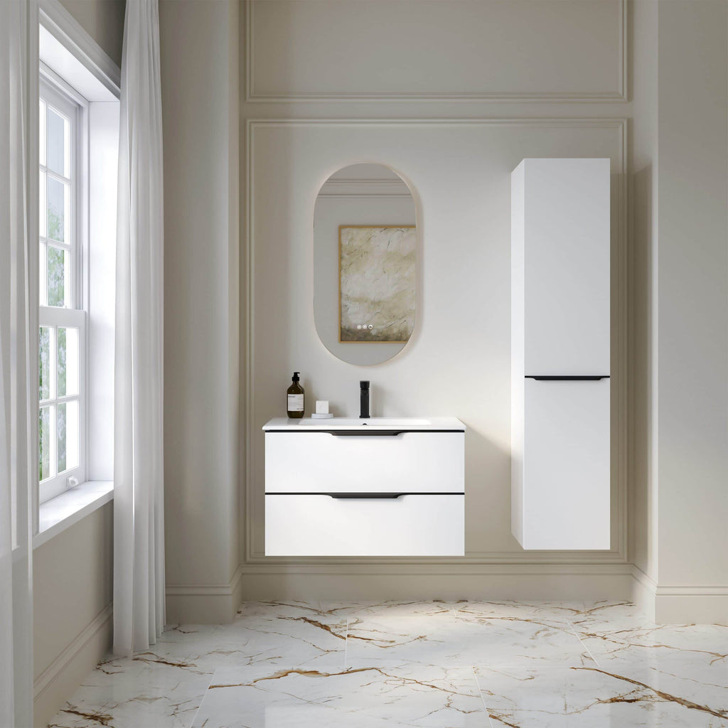 Modern white bathroom vanity with integrated sink, sleek black handles, and matching tall storage cabinet in a bright, elegant bathroom with marble flooring and a large window.
