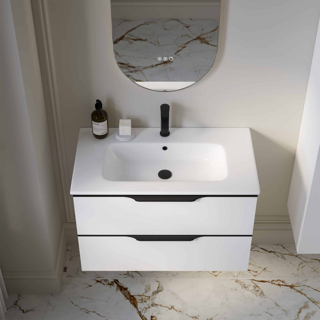 Sleek white bathroom vanity with integrated sink and modern black fixtures, topped with minimalist accessories, set against a sophisticated marble-patterned wall and floor for contemporary bathroom design.