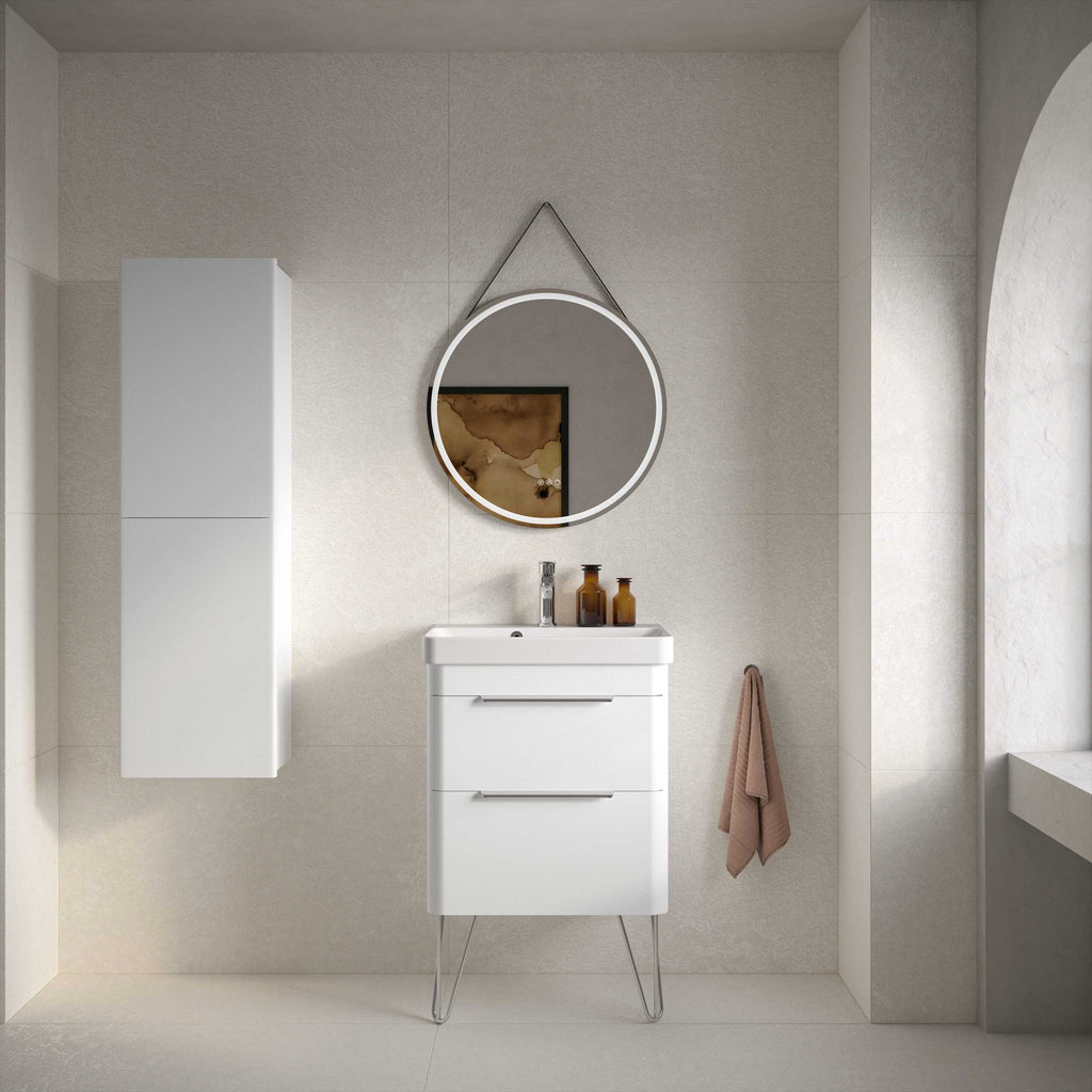 Sleek white bathroom vanity with modern drawer handles, wall-mounted cabinet, and circular mirror with LED lighting in a contemporary bathroom setting.