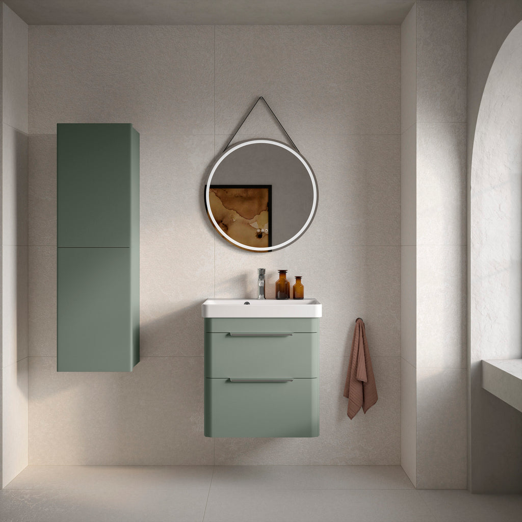 Sleek modern bathroom vanity with green cabinet, circular mirror with LED lighting, wall-mounted storage, and neutral tiles, creating a stylish and functional bathroom space.