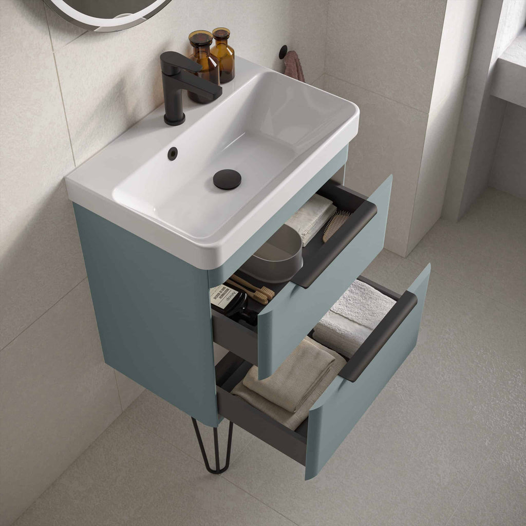 Modern bathroom vanity unit with integrated sink and open storage drawers, featuring sleek black handles and black tap, perfect for contemporary bathroom decor.