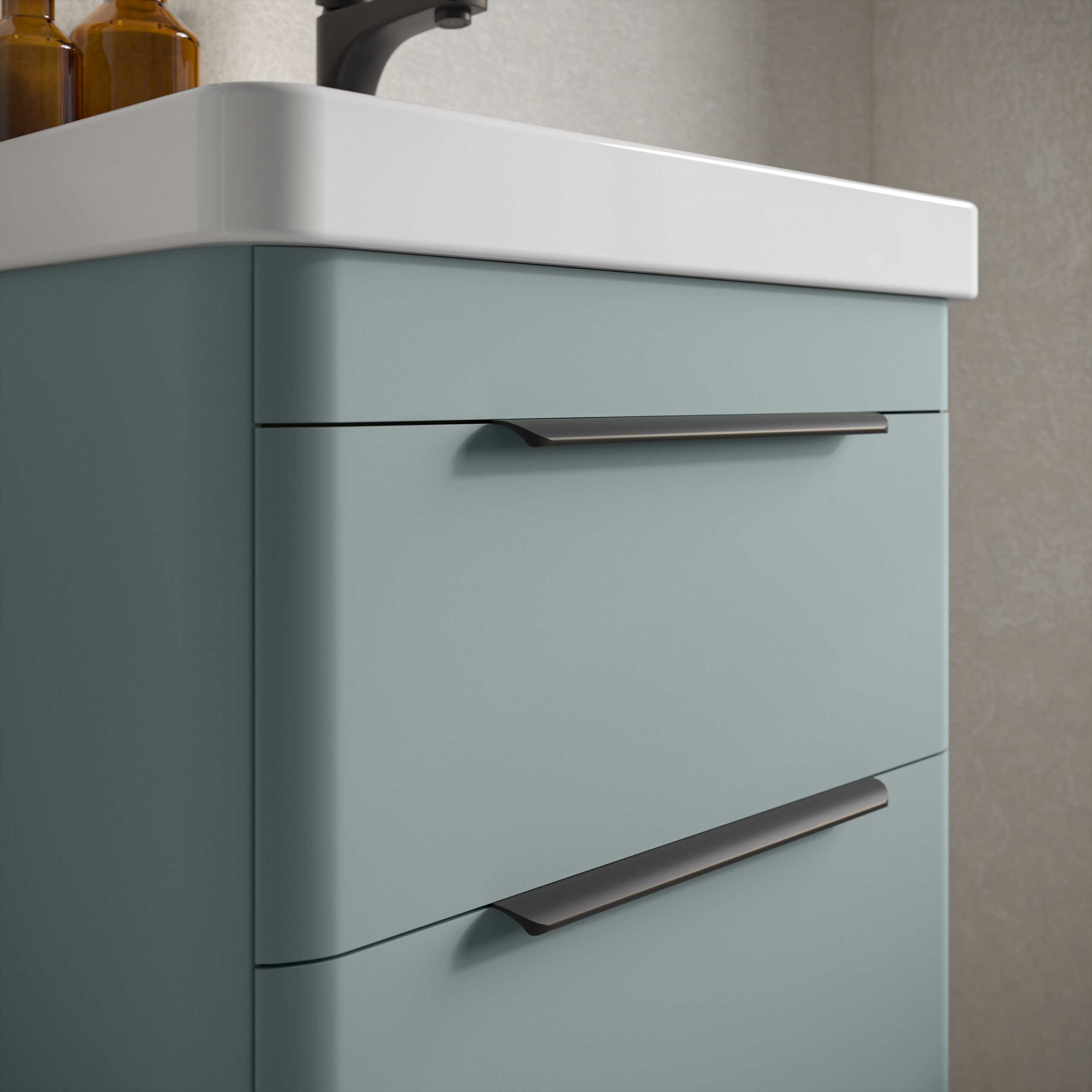 Sleek blue bathroom vanity with modern black handles, featuring a white countertop and integrated sink, perfect for contemporary bathroom design.