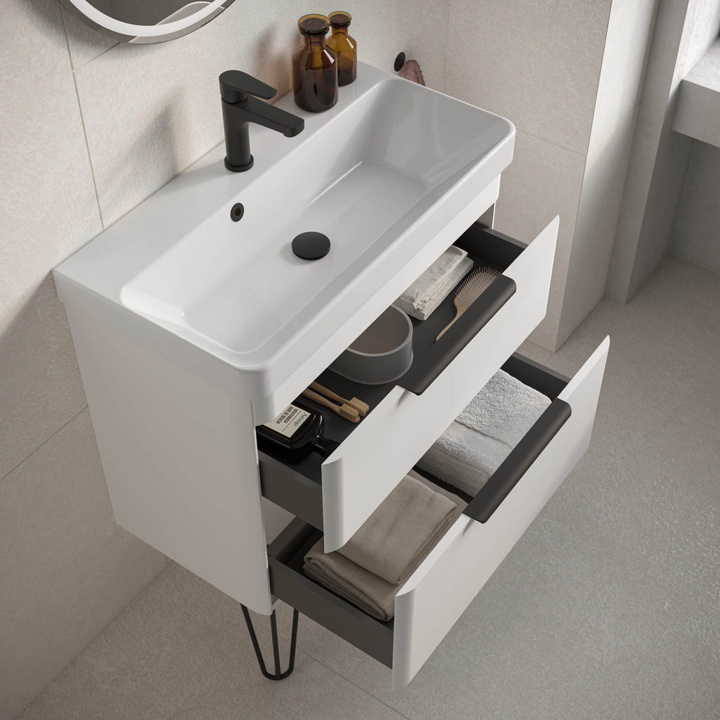 Modern white bathroom vanity with black hardware and open drawers, featuring a compact sink with matte black faucet, ideal for contemporary bathroom design and storage optimization.