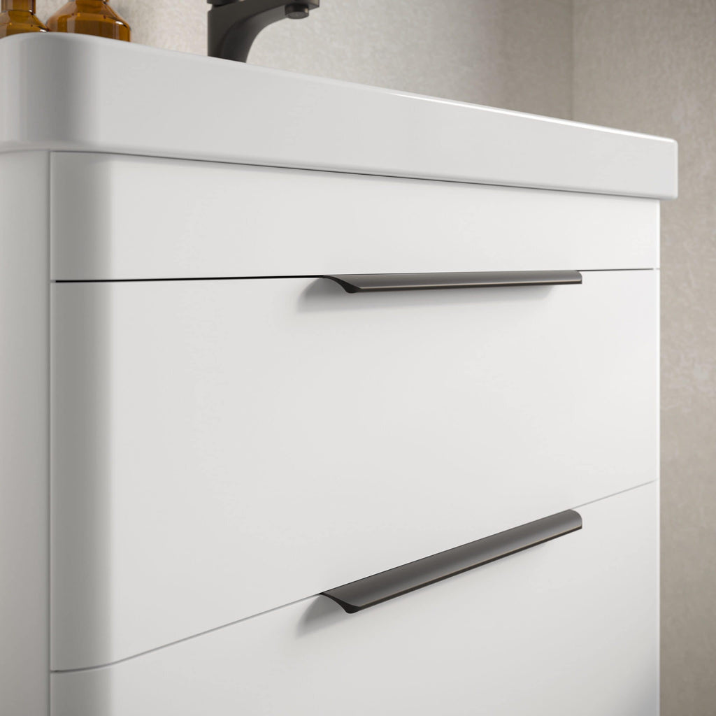 White bathroom vanity unit with sleek black handles, modern and minimalist design, ideal for contemporary bathrooms, includes spacious drawers for storage, high-quality finish, perfect for bathroom organisation and style.