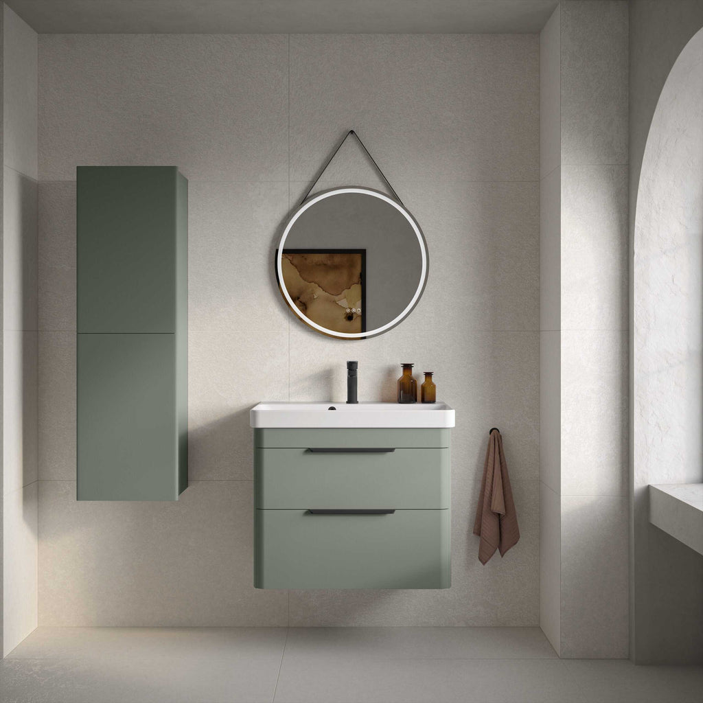 Sleek green bathroom vanity unit with a matching wall-mounted cabinet, modern round mirror with LED lighting, brown glass bottles, and a soft brown towel, creating a minimalist and contemporary bathroom design.