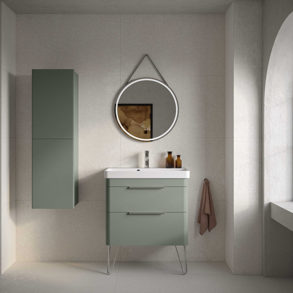 Modern green bathroom vanity with sleek drawers and a semi-hidden toilet, minimalist wall-mounted cabinet, circular backlit mirror, beige tiles, and elegant decor for contemporary bathroom design.