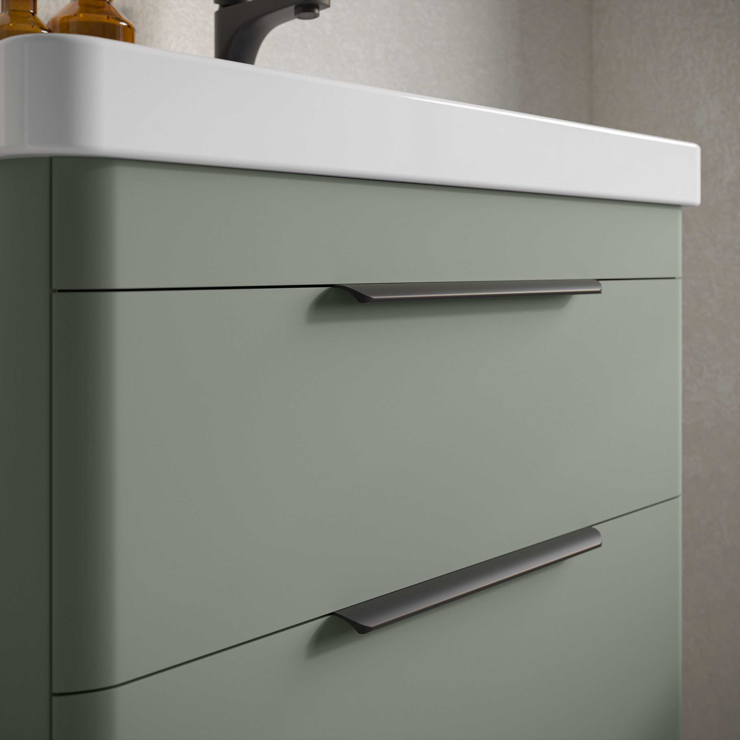 Brushed metal drawer handles on pastel green bathroom vanity with white countertop and black tap, modern bathroom furniture design, sleek and contemporary bathroom cabinetry, minimalist bathroom storage solution, quality bathroom furniture by Bubly Bathrooms.
