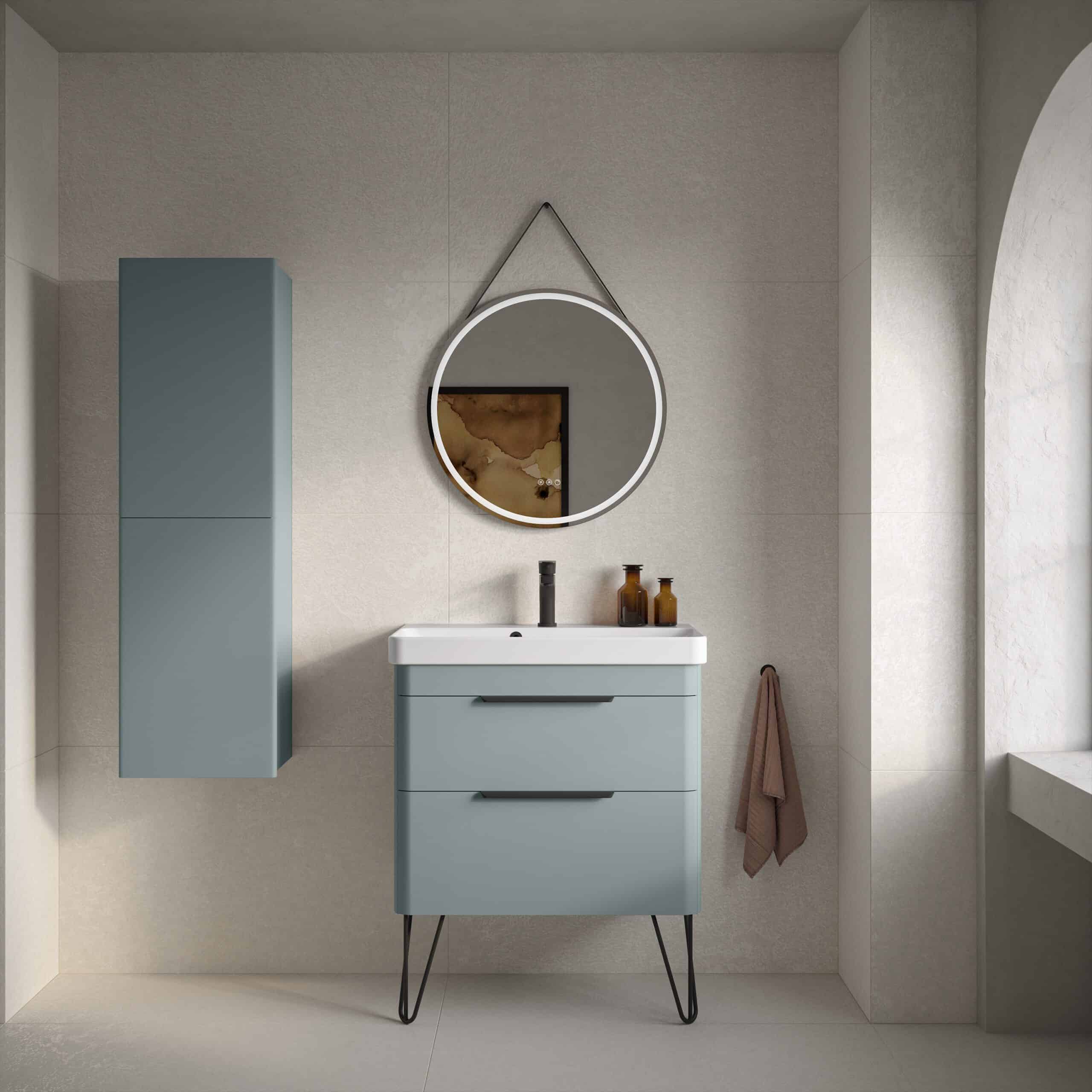 Sleek modern blue bathroom vanity with white sink and black fixtures, wall-mounted round mirror with LED lighting, and minimalist decor, creating a stylish and functional bathroom space.