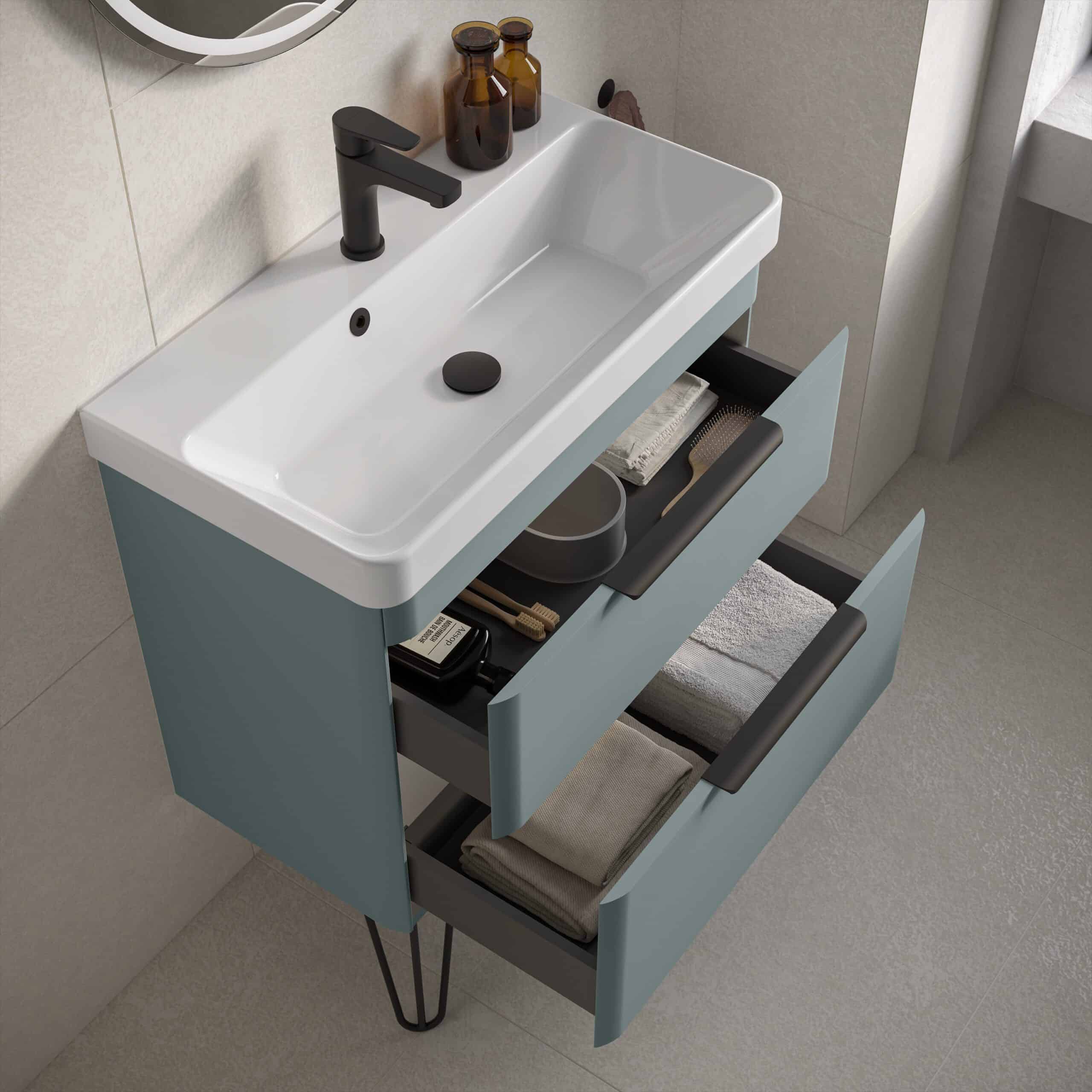 Modern bathroom vanity with white ceramic sink and open drawers containing towels, toiletries, and grooming essentials, showcasing stylish and functional bathroom storage solutions.