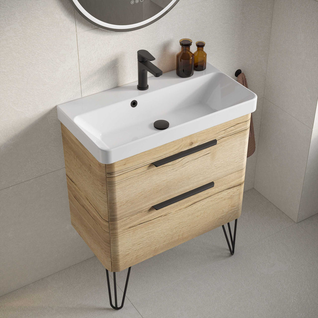 Modern bathroom vanity with a sleek white ceramic sink, black tap, and wooden cabinets on stylish hairpin legs, perfect for contemporary bathrooms.