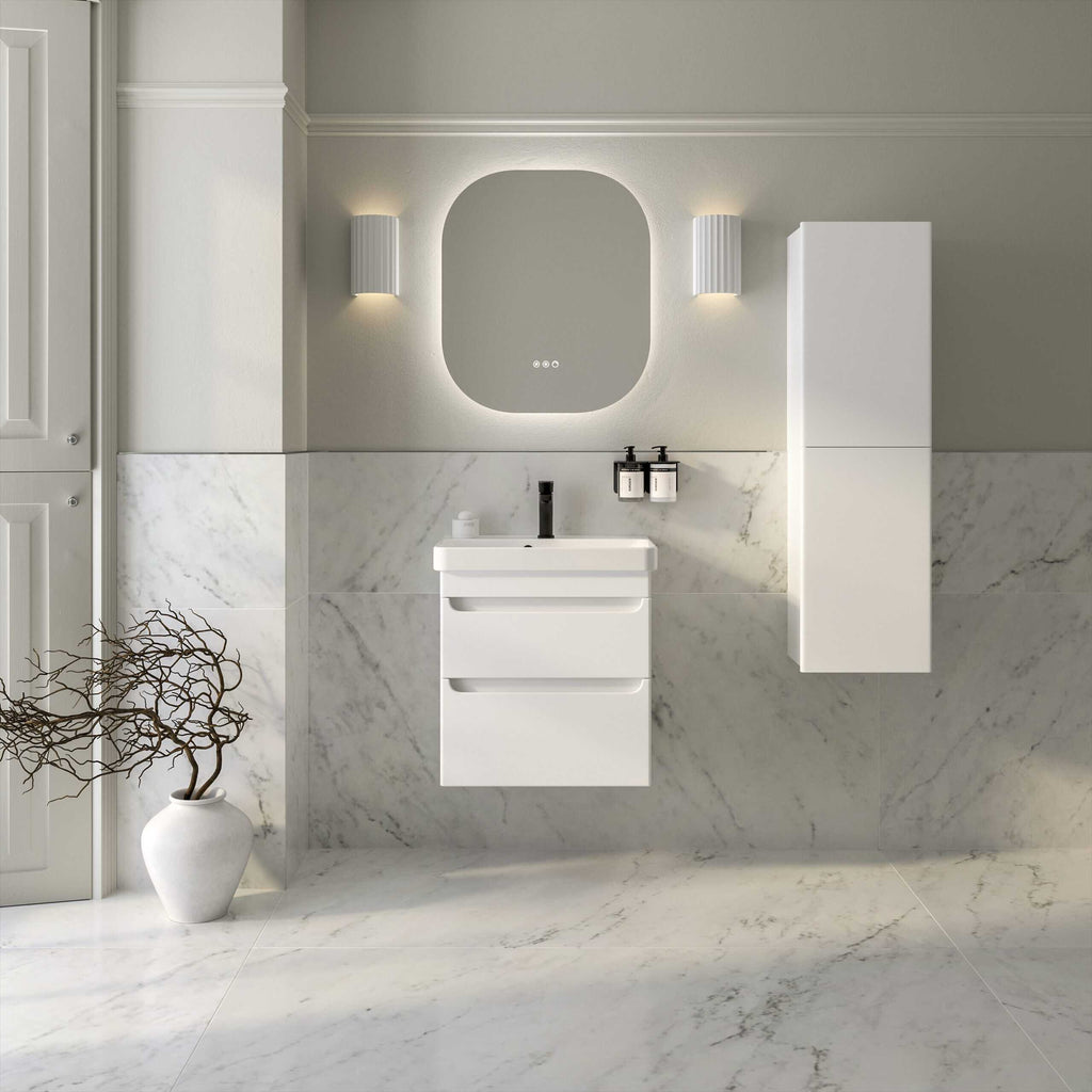 Sleek white bathroom vanity with integrated sink, modern black tap, and wall-mounted cabinet in a contemporary marble-tiled bathroom with minimalistic design.