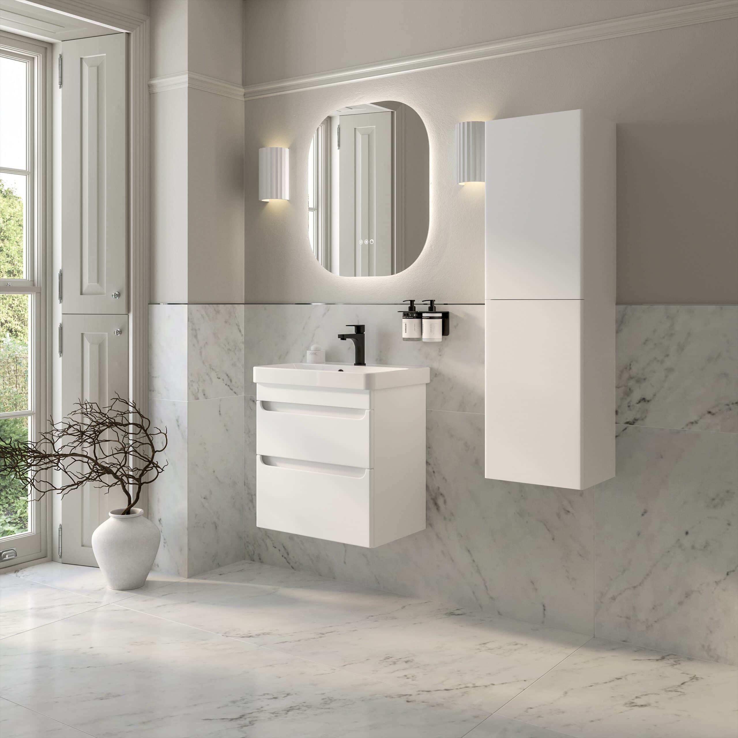 Sleek modern white bathroom vanity with drawers and a black faucet, mounted on a marble wall in a bright, contemporary bathroom with a large mirror and wall-mounted storage cabinet.