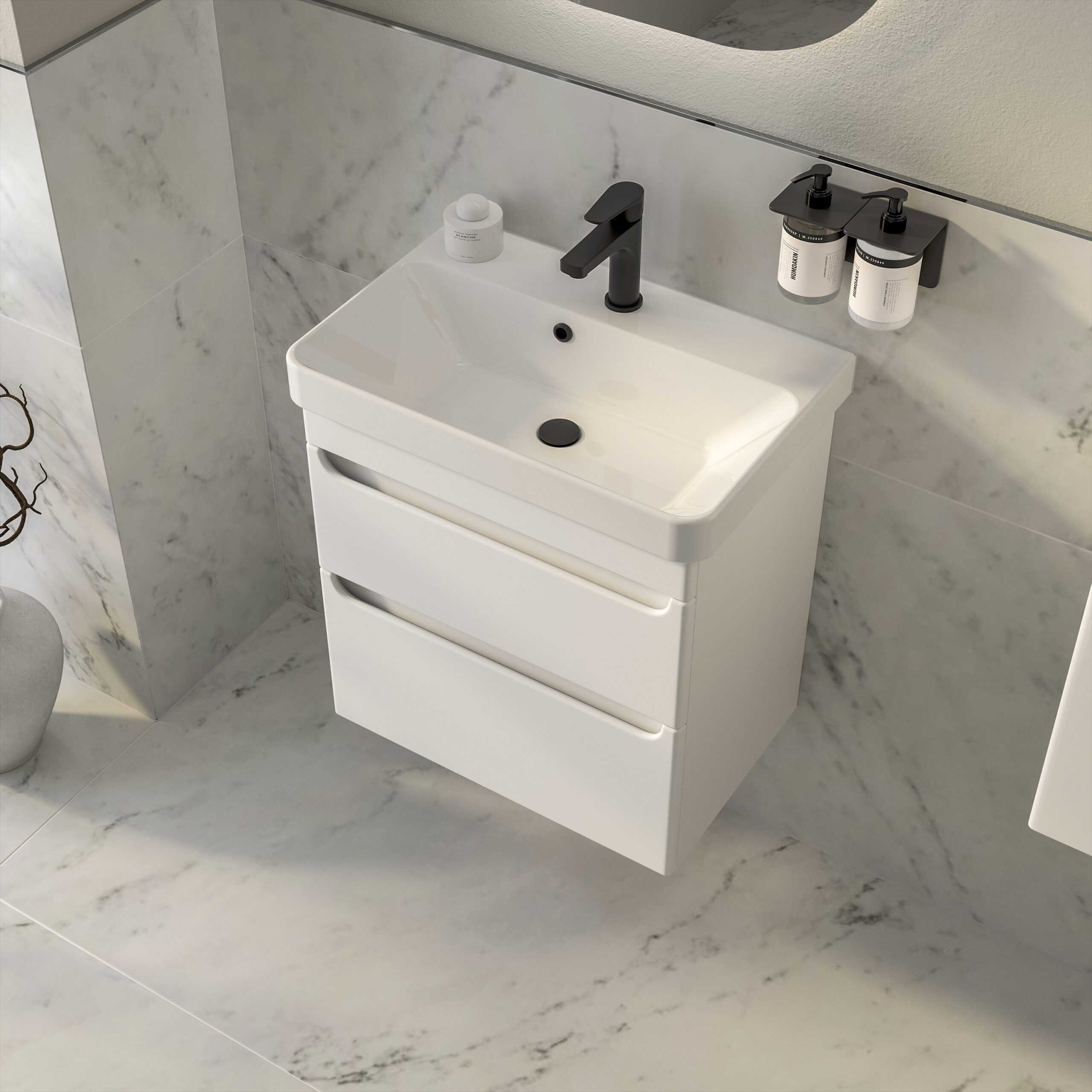Modern white bathroom vanity with integrated sink, matte black tap, storage drawers, and marble-effect wall and floor tiles, creating a sleek, contemporary bathroom design.