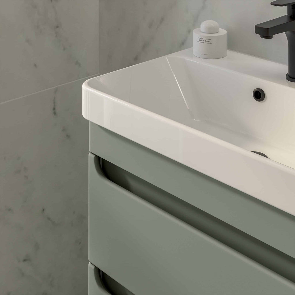 Modern white bathroom sink with sleek black faucet and matching accessories by Bubly Bathrooms, demonstrating contemporary bathroom design and quality craftsmanship.