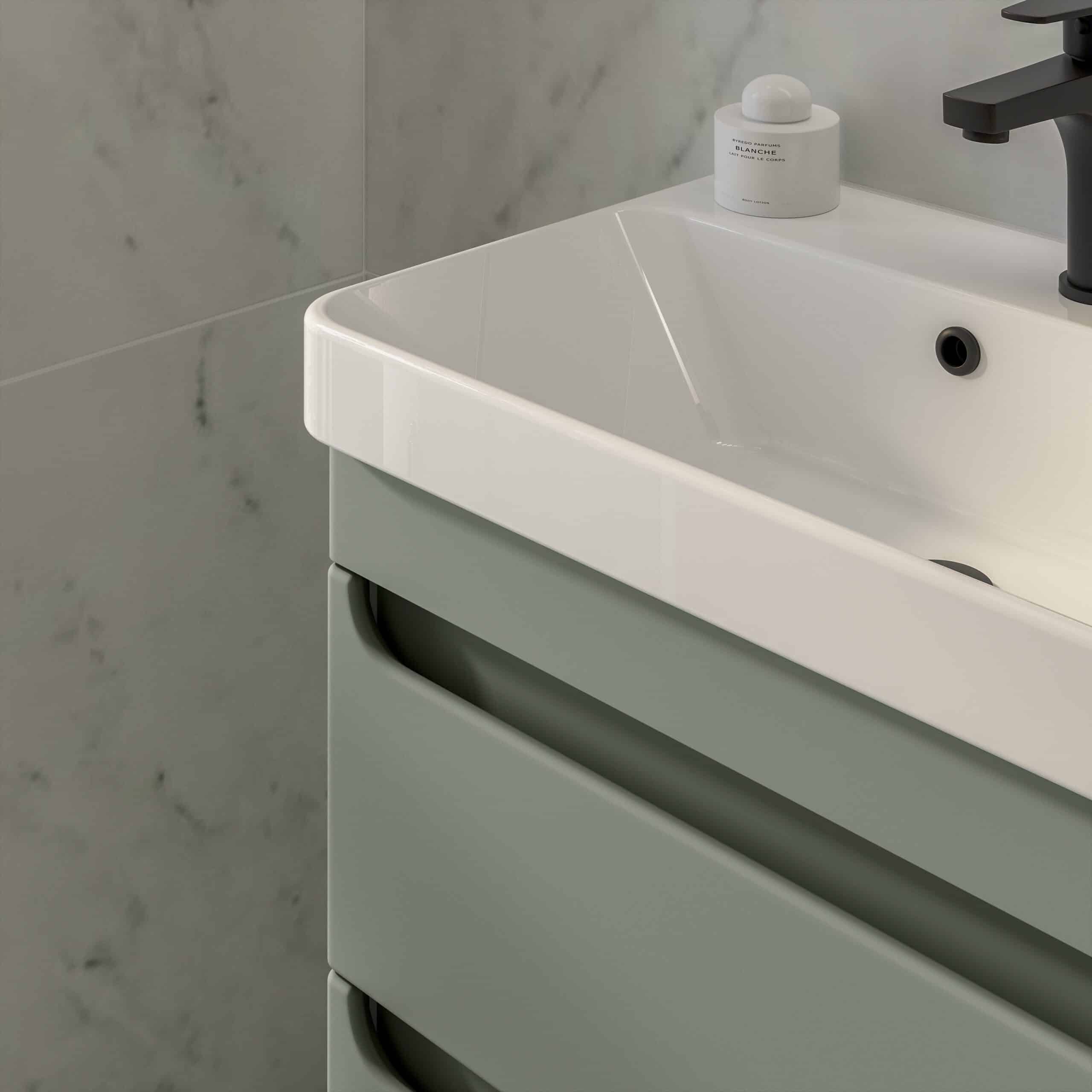 Modern white bathroom sink with sleek black faucet and matching accessories by Bubly Bathrooms, demonstrating contemporary bathroom design and quality craftsmanship.
