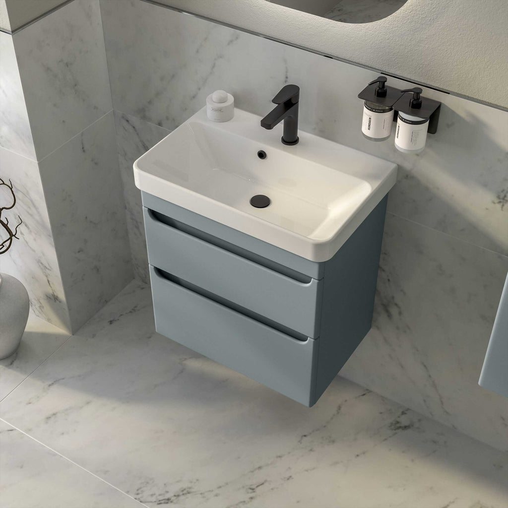 Modern bathroom vanity with a sleek white ceramic sink, black tap, and light grey storage drawers, ideal for contemporary bathroom décor and storage solutions.