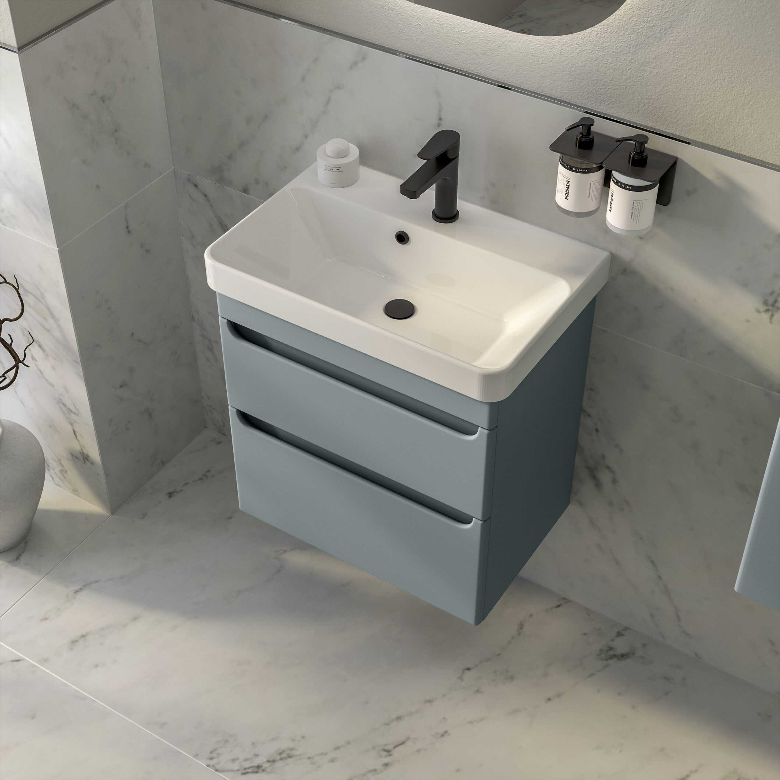 Modern bathroom vanity with a sleek white ceramic sink, black tap, and light grey storage drawers, ideal for contemporary bathroom décor and storage solutions.