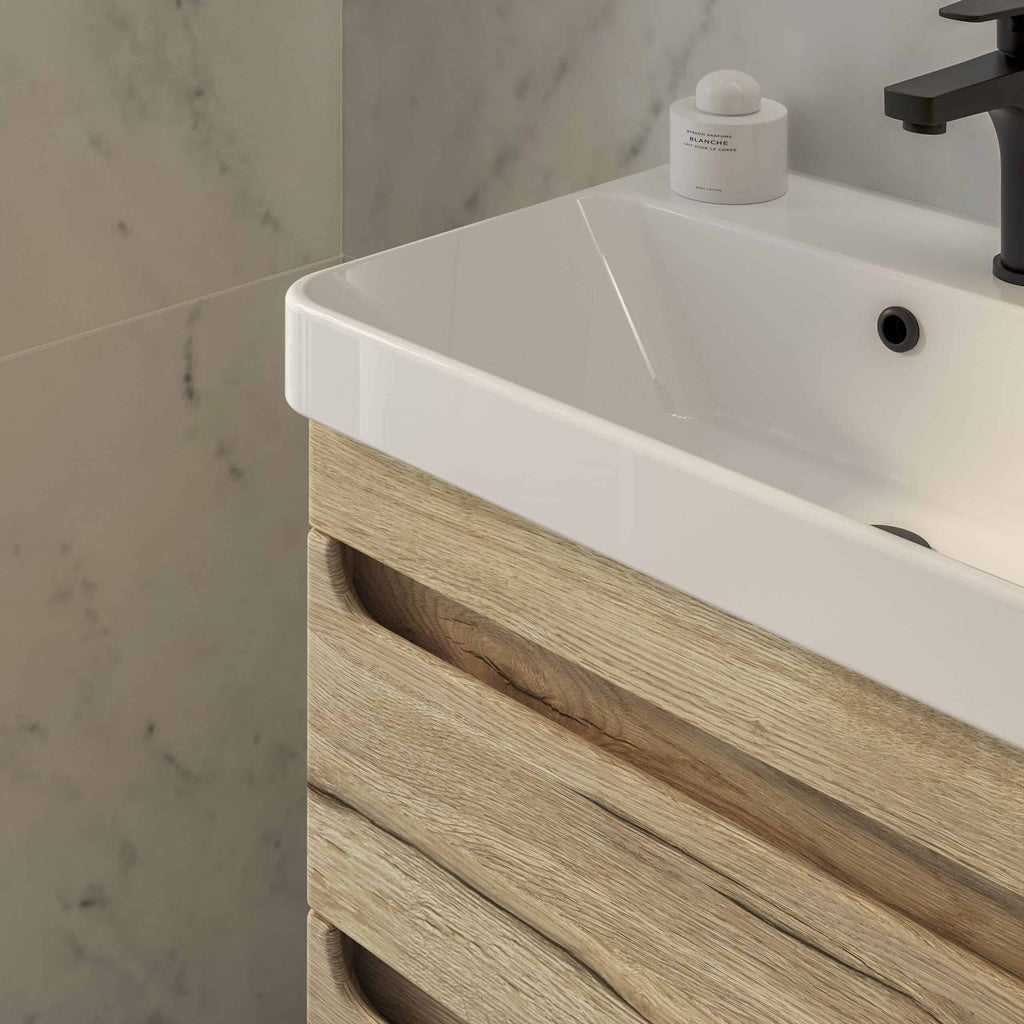 Sleek white bathroom sink with a wooden vanity unit, modern black tap, and marble tiled wall, perfect for contemporary bathroom design and renovation.