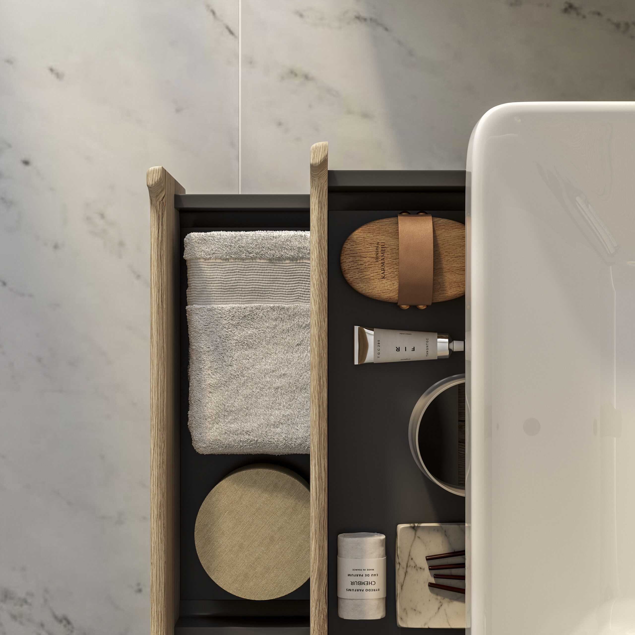 Stylish bathroom storage drawer with modern towels, skincare products, and accessories on a marble countertop, showcasing elegant bathroom organisation ideas for contemporary interiors.